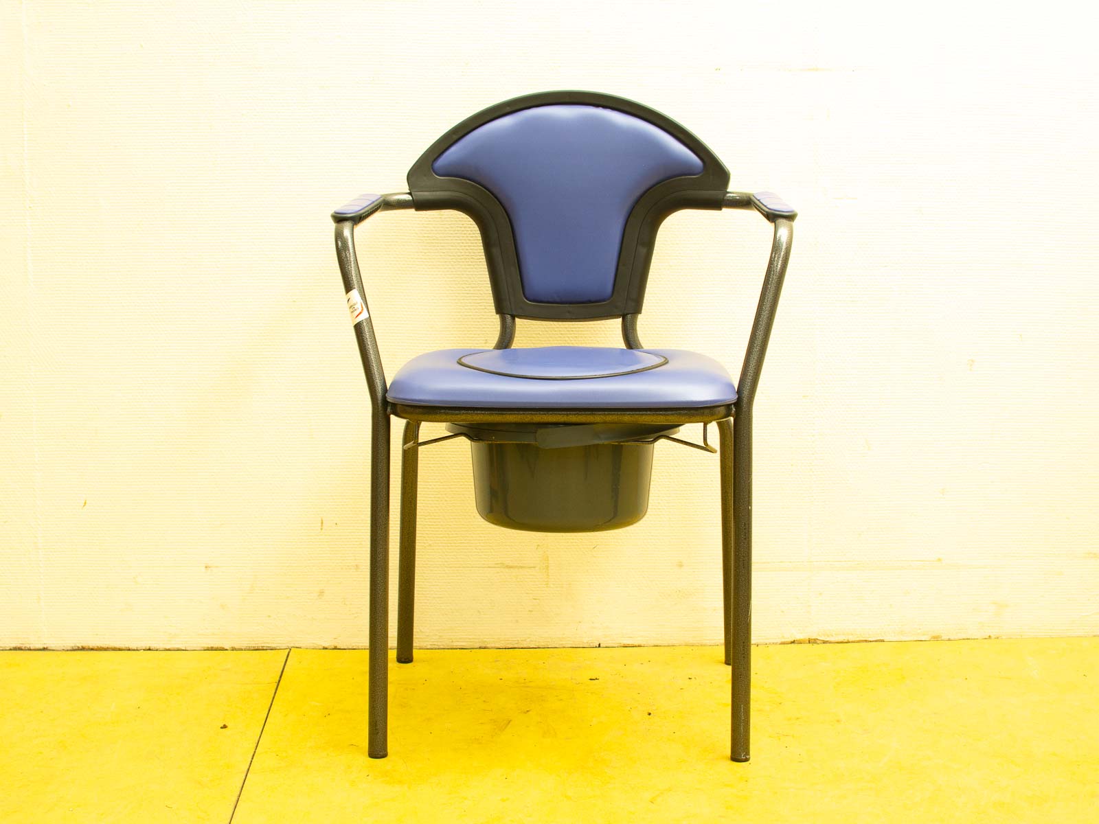 Modern blue chair with black frame and storage bin for comfort and versatility.