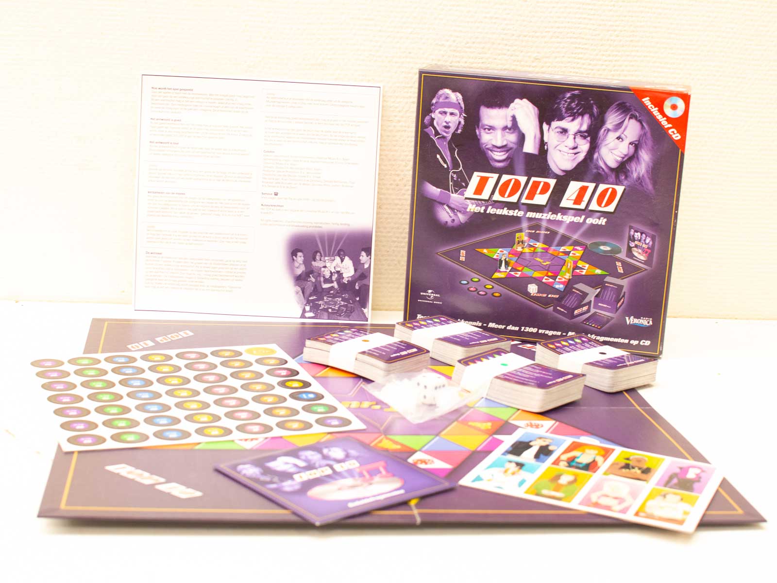 Vibrant music-themed board game, TOP 40, featuring trivia cards, tokens, and a CD for fun nights.