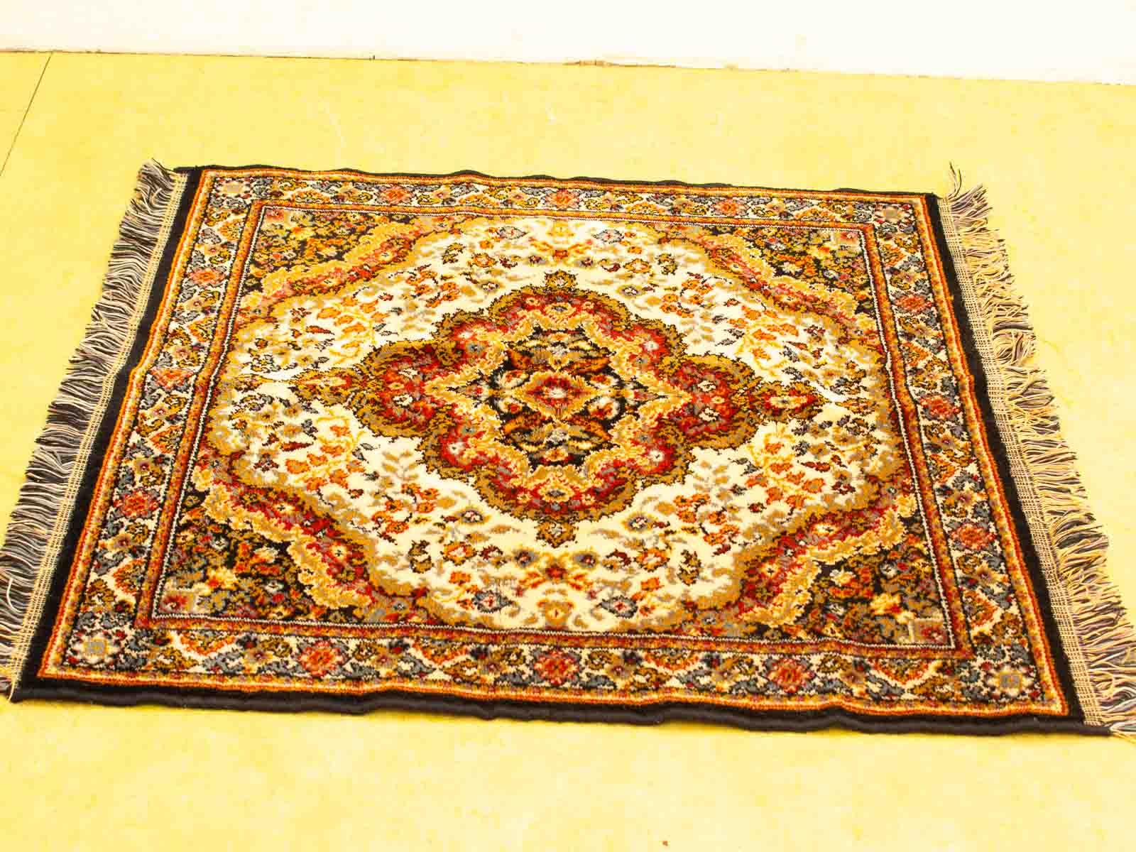 Elegant Persian rug with floral patterns, vibrant colors, and fringed edges for inviting decor.