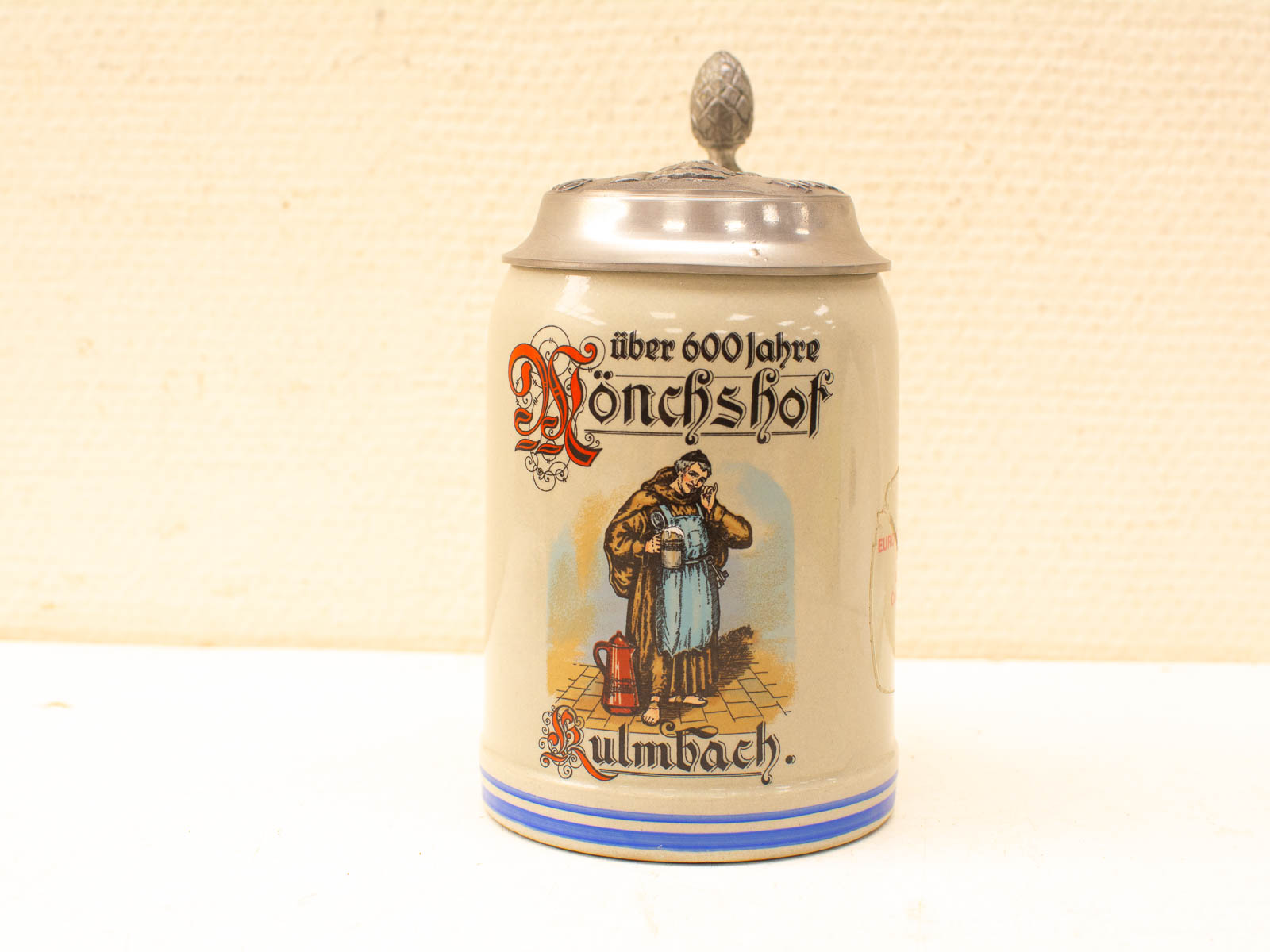 Bavarian beer stein with lid, showcasing vibrant artwork and Mönchshof heritage from Kulmbach.