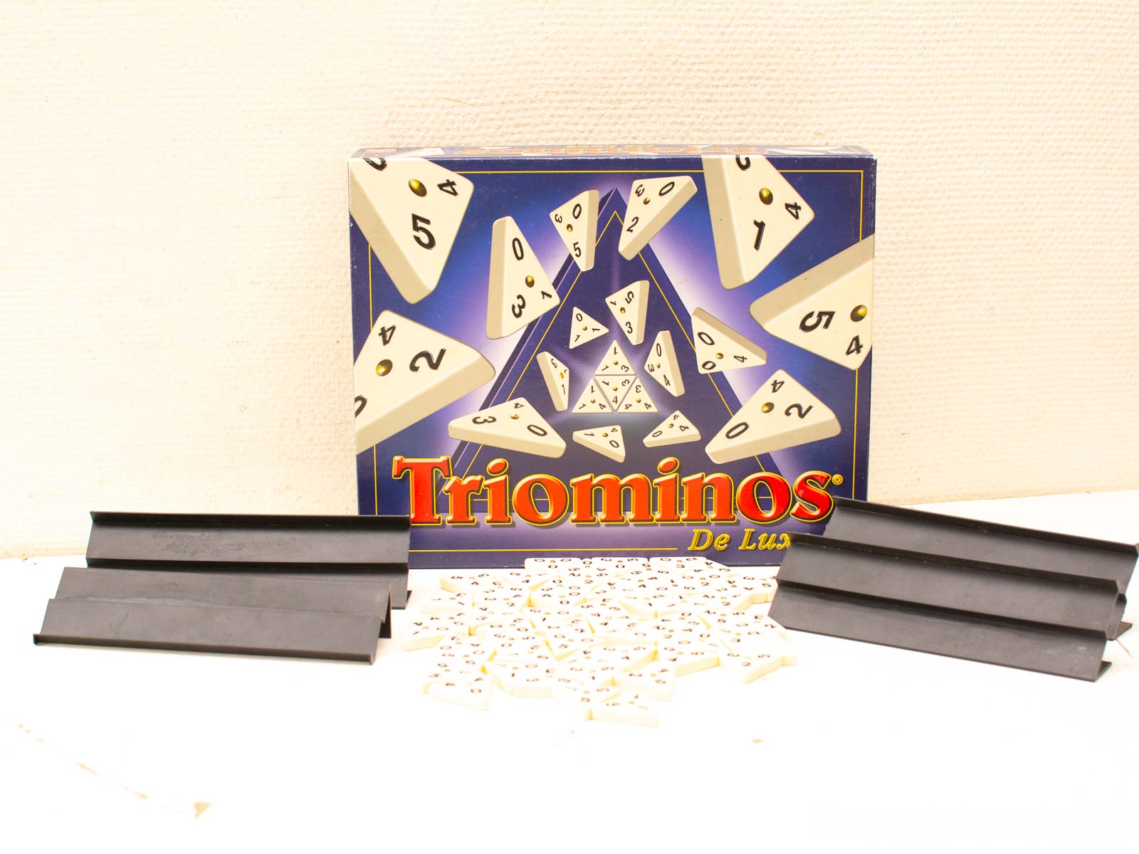 Vintage Triominos De Luxe board game with colorful triangular pieces for strategic fun.