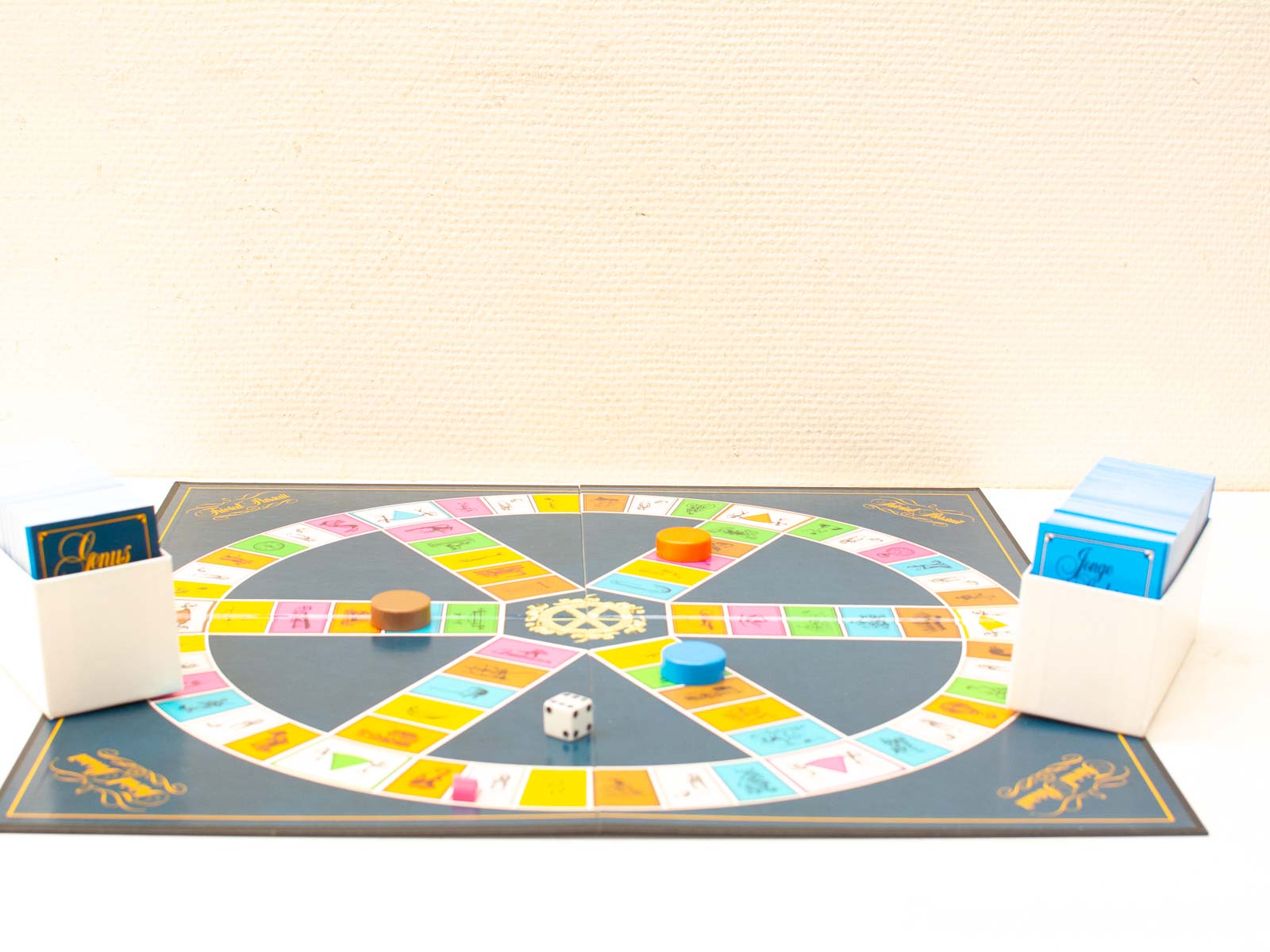 Colorful circular board game with dice, tokens, and card decks for engaging gameplay.