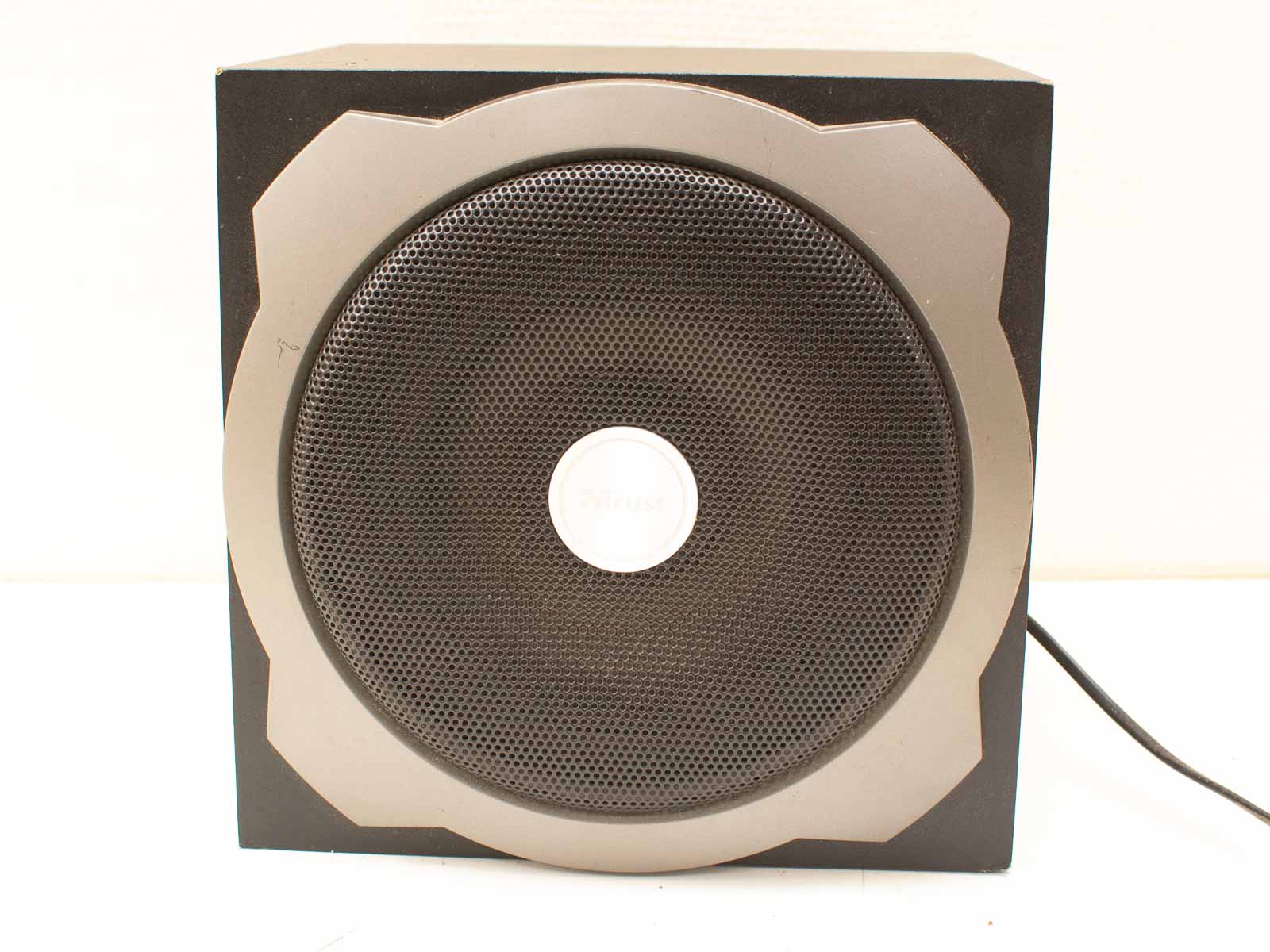 Sleek black compact speaker with a modern design and stylish circular grille for any space.