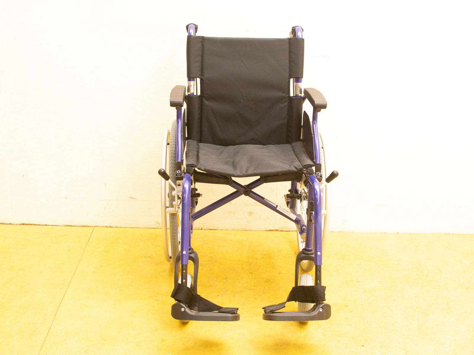 Lightweight purple wheelchair with comfortable black fabric, perfect for mobility and stylish support.