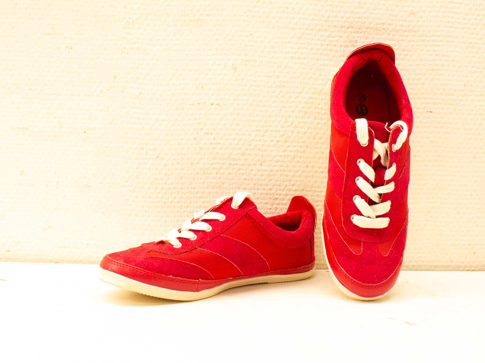 Stylish red sneakers with a sporty design, perfect for casual wear and light activities.