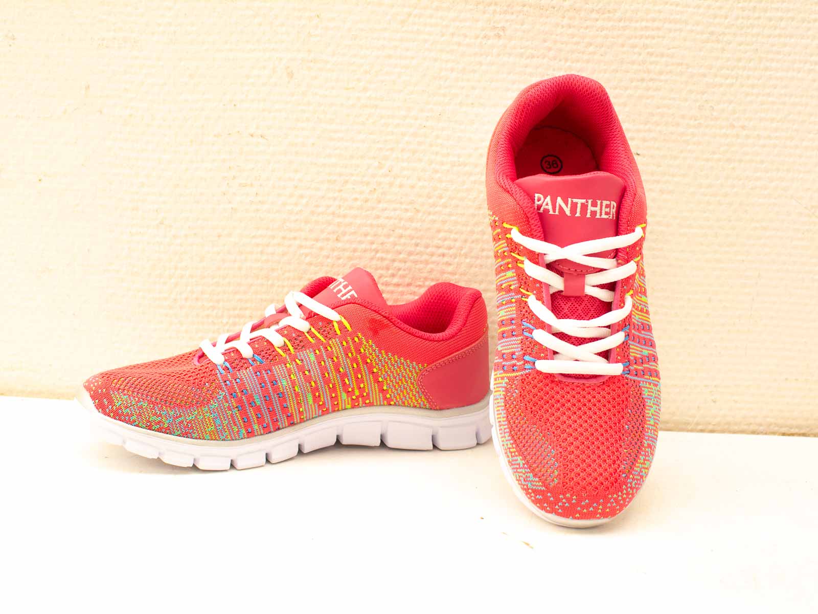 Bright pink athletic shoes with vibrant accents for style, comfort, and performance in any activity.