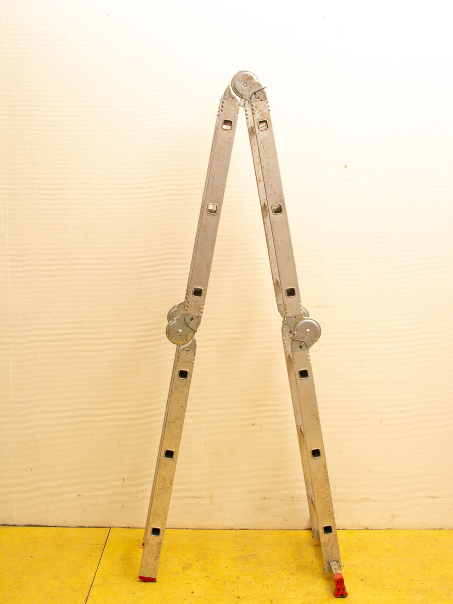 Durable vintage aluminum A-frame folding ladder, ideal for home improvement and construction tasks.