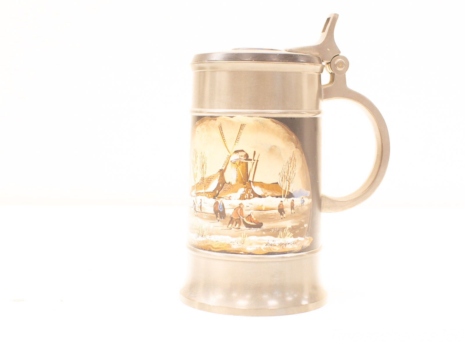 Vintage beer stein showcasing a winter landscape with a windmill and joyful ice-skating scene.