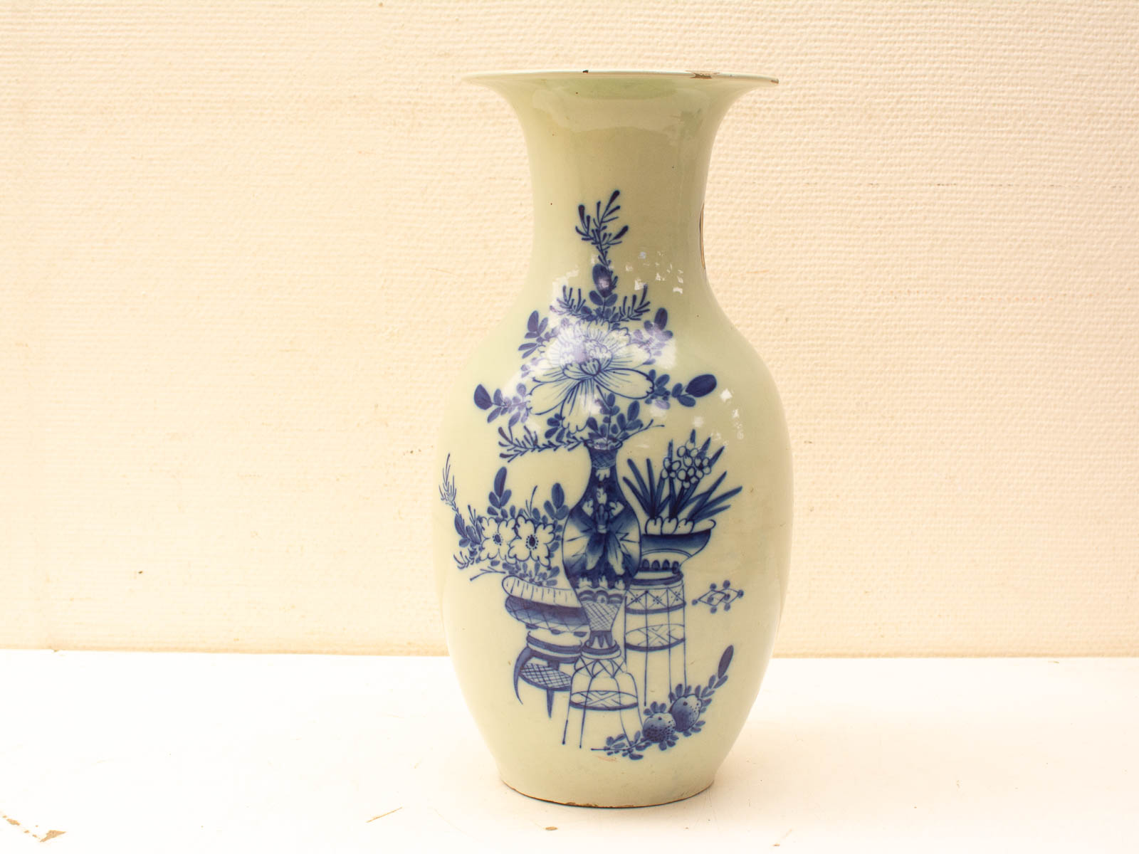 Elegant vintage vase with pastel green glaze and intricate blue floral designs. Perfect decor piece.