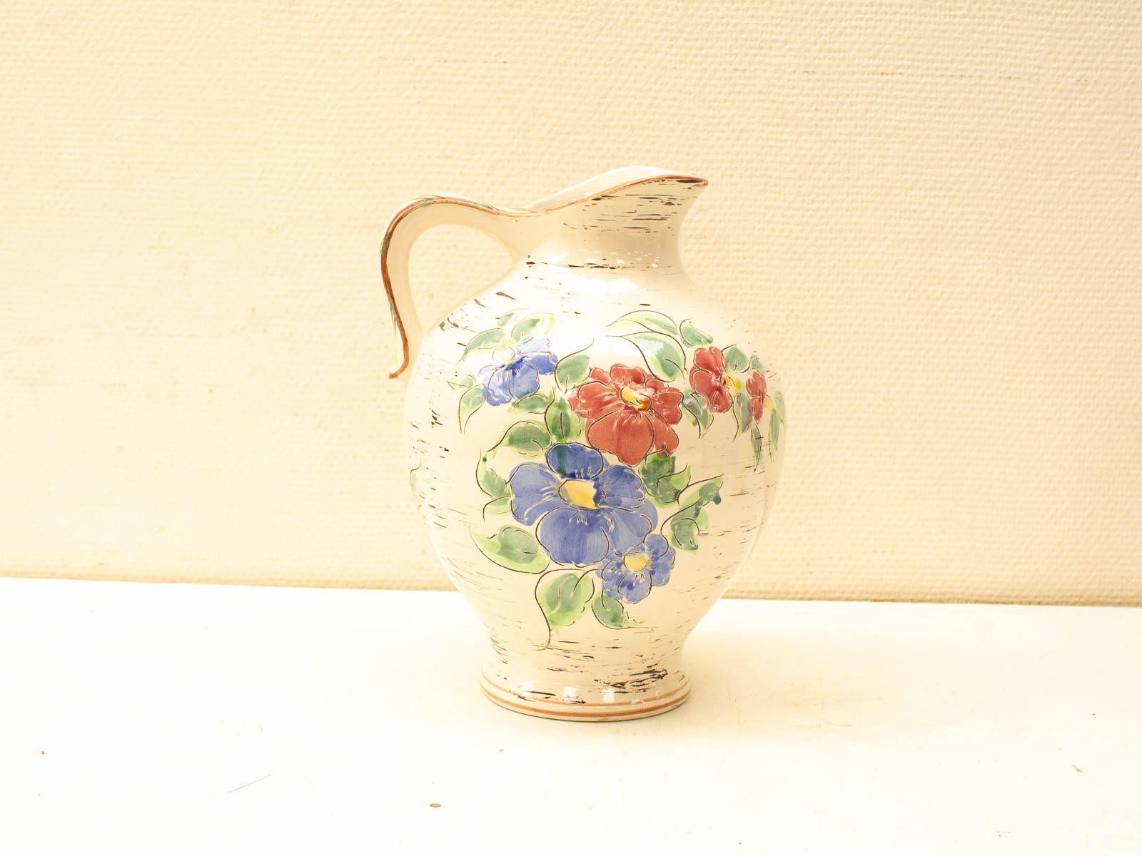 Elegant vintage ceramic pitcher with vibrant floral designs, perfect for decor and collectors.