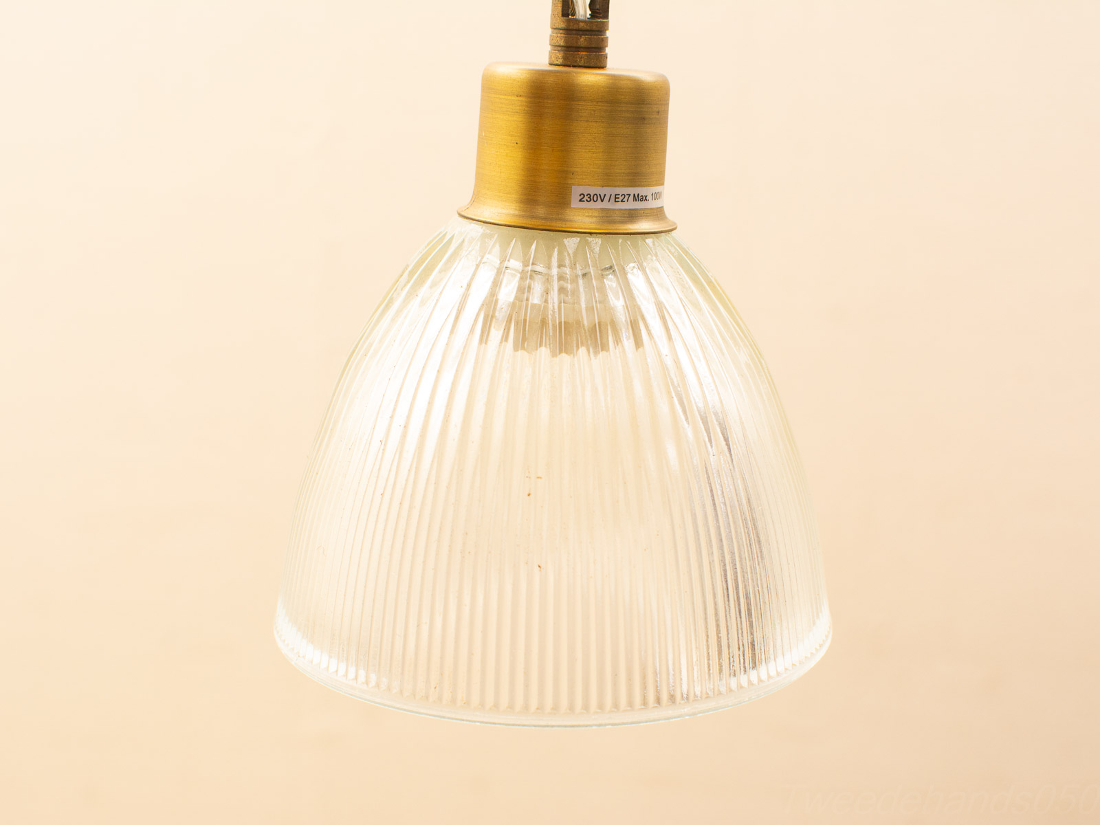 Ribbed glass pendant lamp with brass fixture, blending vintage charm and modern elegance.