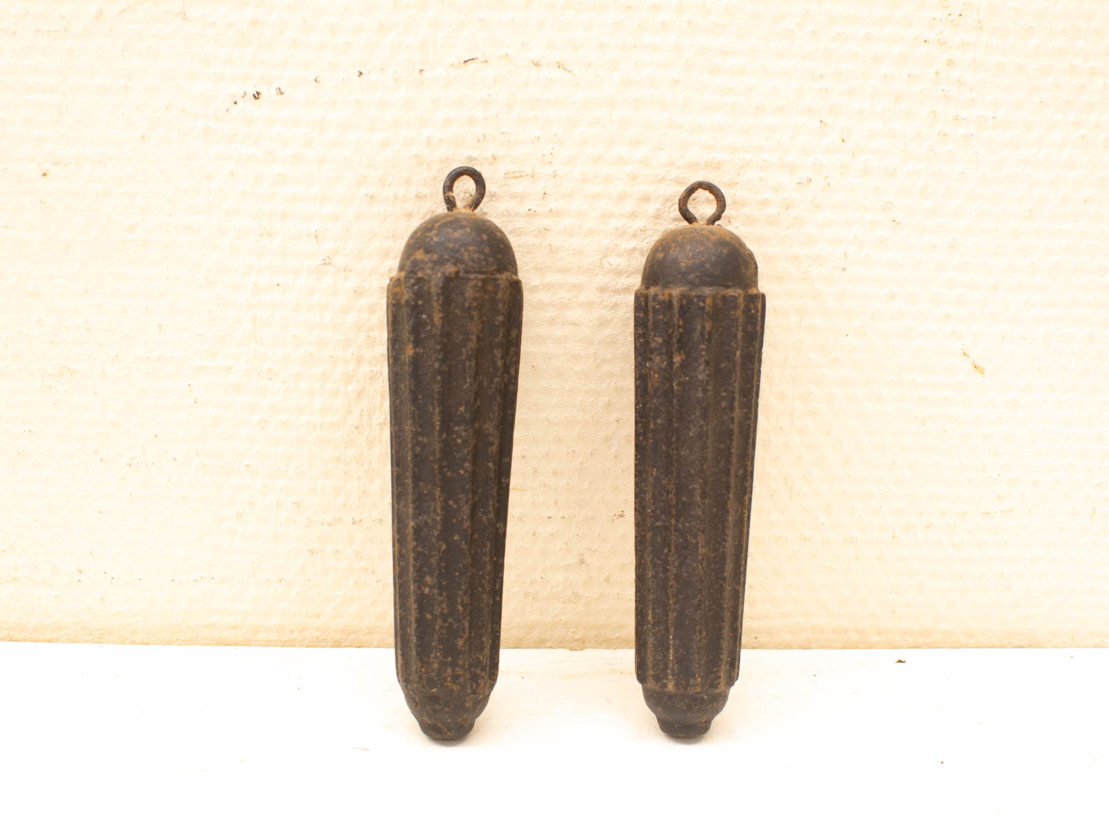 Pair of vintage cylindrical objects with ridges, patina, perfect for decorative or functional use.