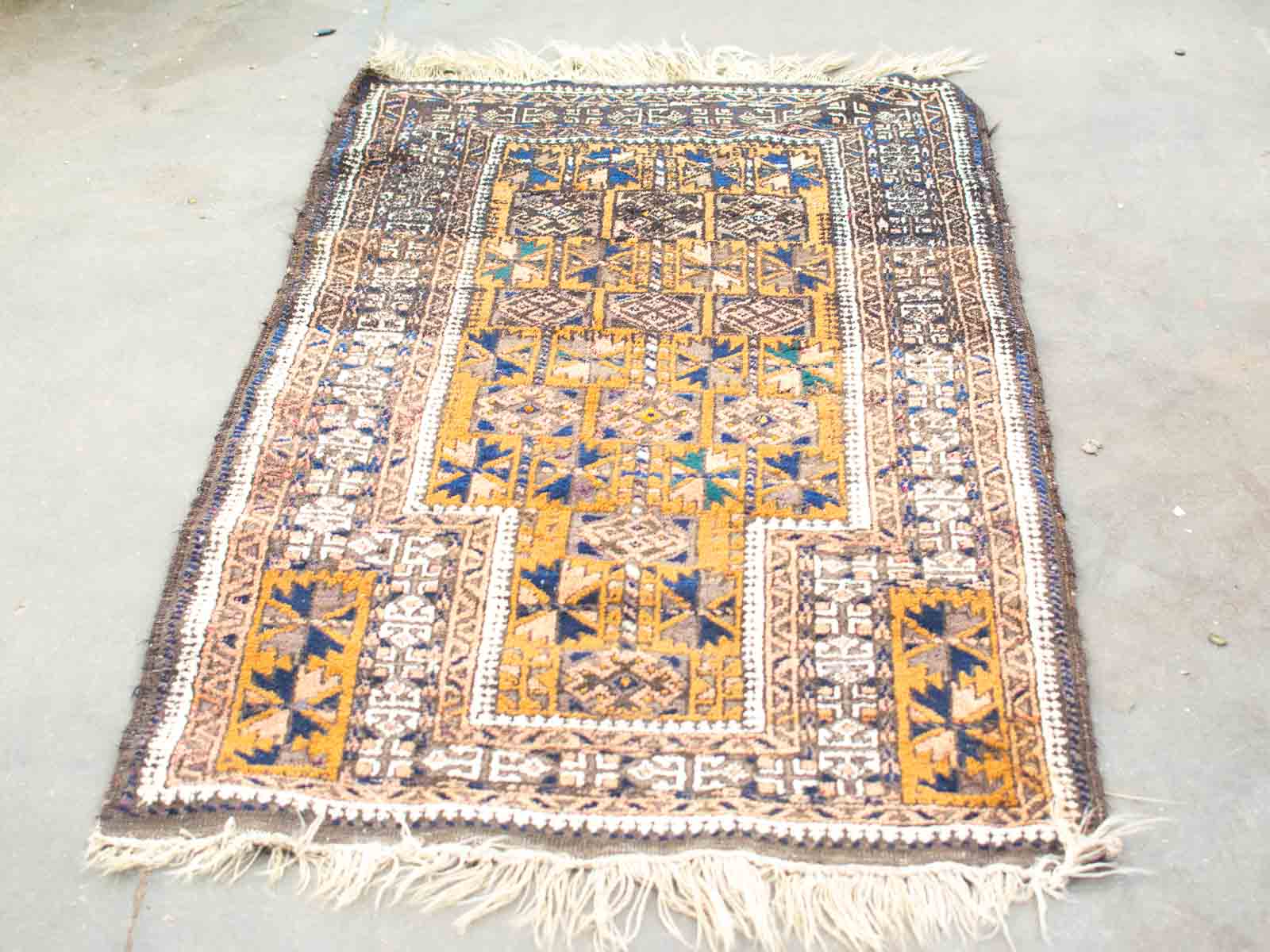 Vintage woven rug showcasing intricate geometric patterns in rich colors, perfect for adding cultural charm.