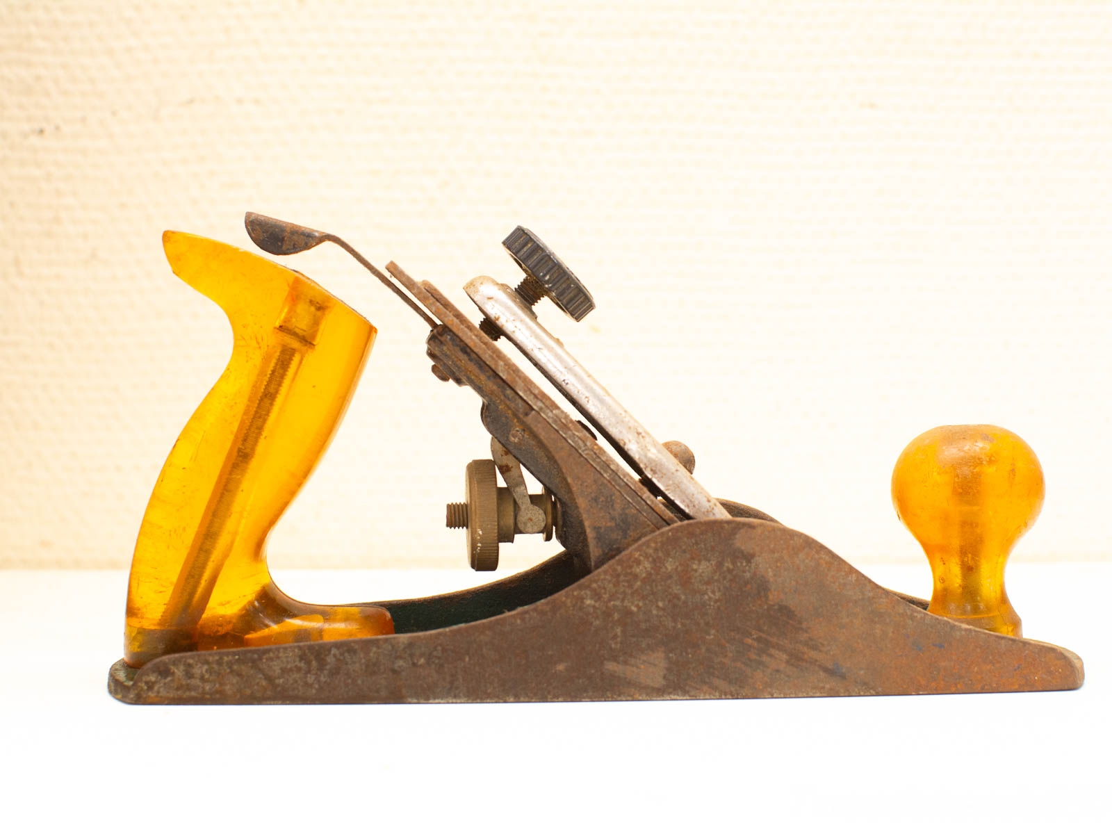 Vintage hand plane with yellow handle, showcasing fine craftsmanship for woodworking enthusiasts.