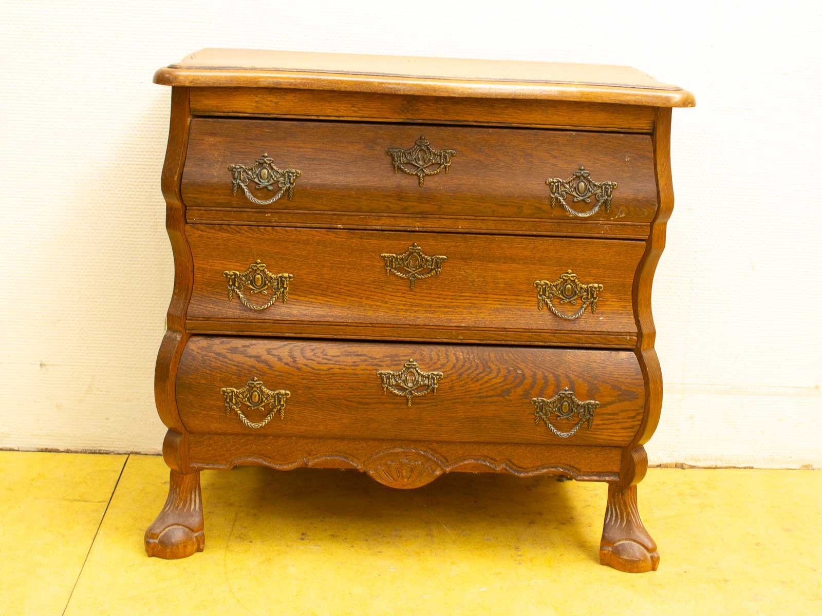 Elegant vintage wooden dresser with ornate brass handles and a charming design for any decor.