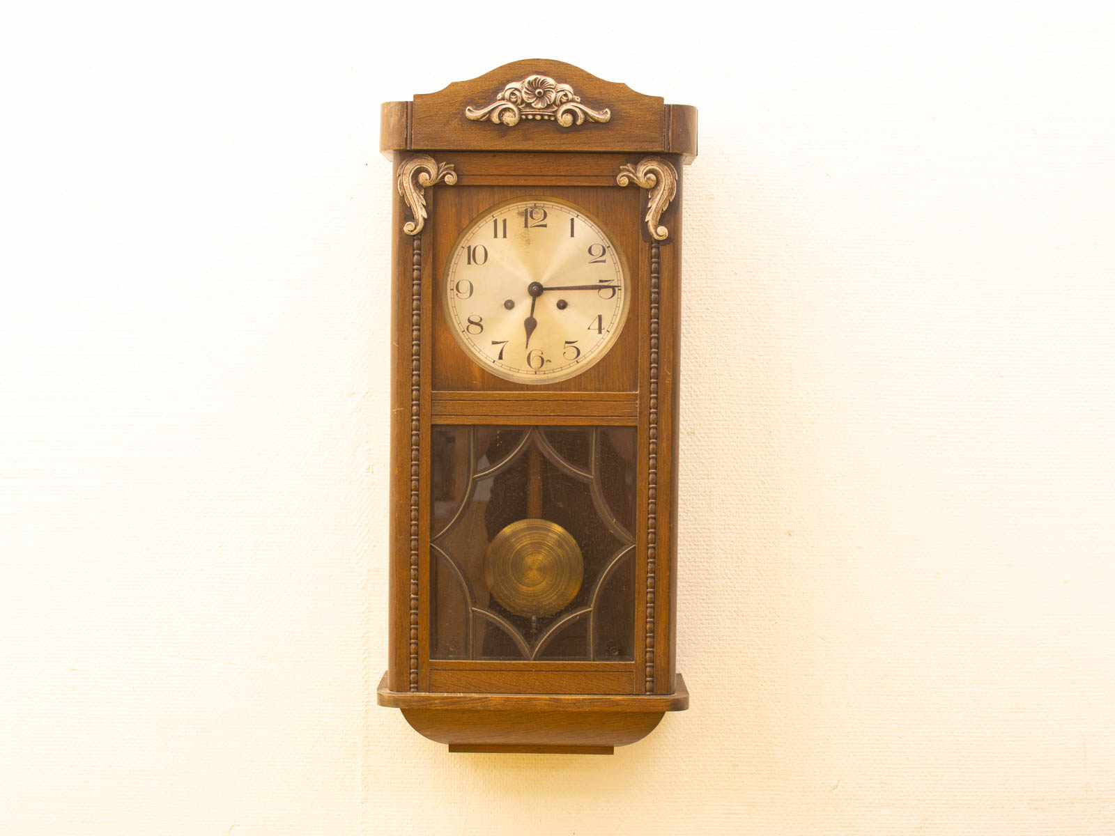 Elegant vintage wall clock with floral design and rich wooden frame, perfect for any decor.