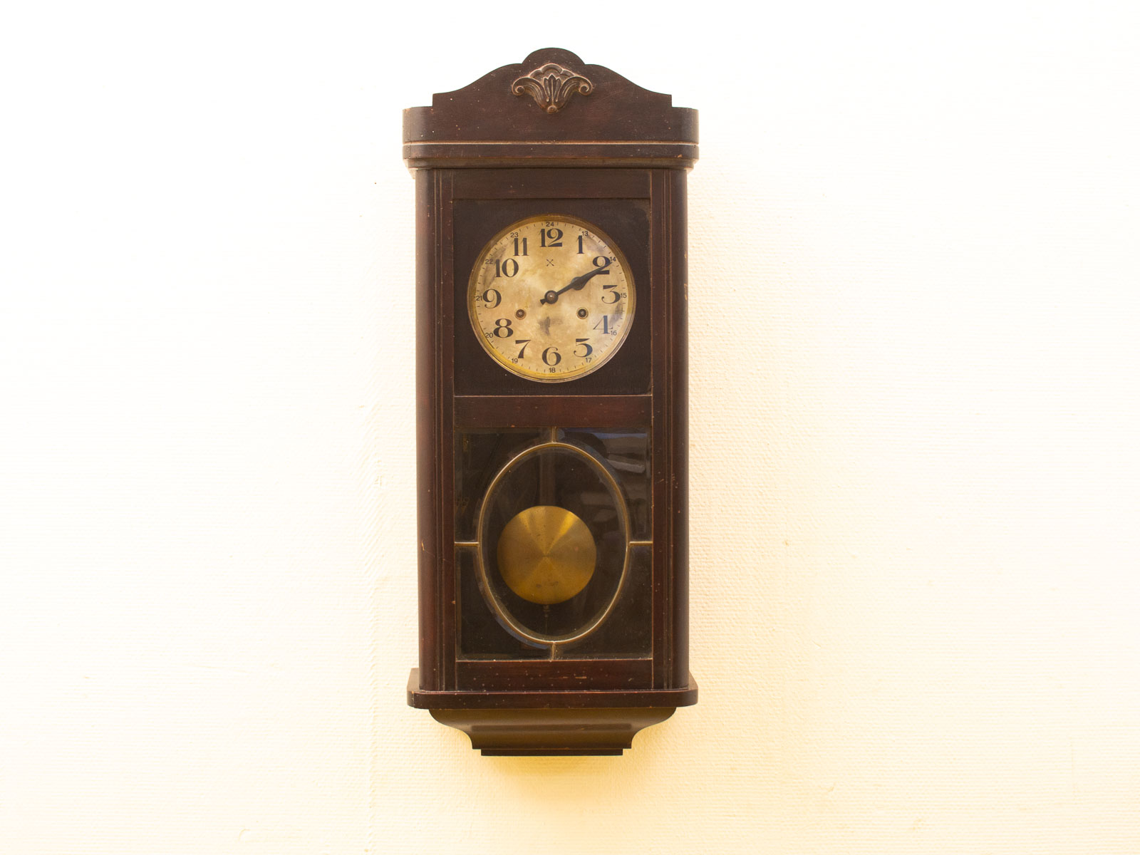 Elegant vintage wooden wall clock with pendulum, classic design, and polished finish. Perfect for collectors.