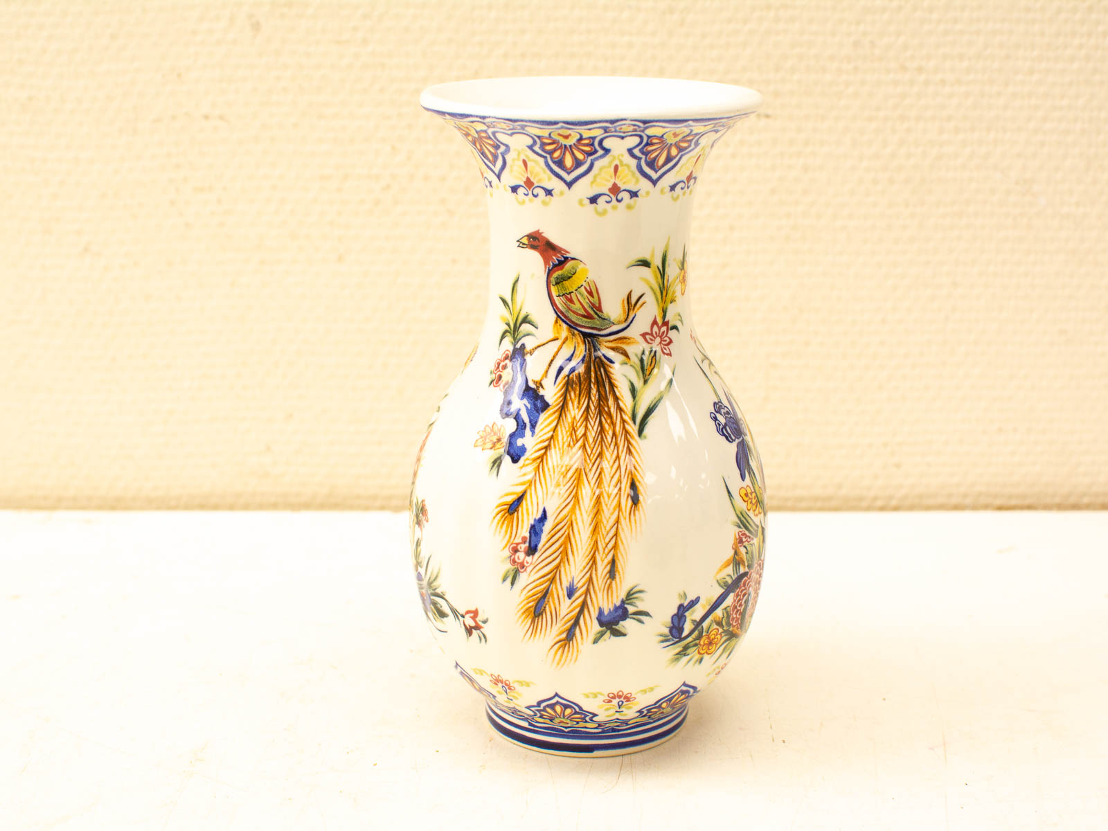 Colorful vintage vase with intricate floral and bird designs, perfect for enhancing any decor.