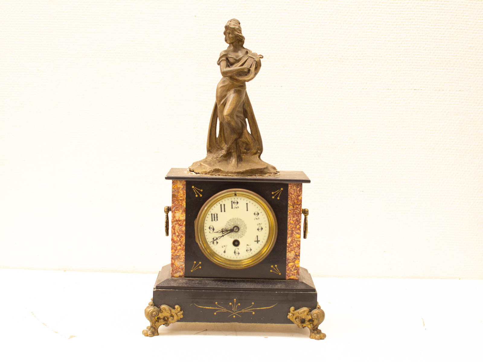 Elegant vintage clock with musician statue, ornate design, and marbled accents for timeless decor.