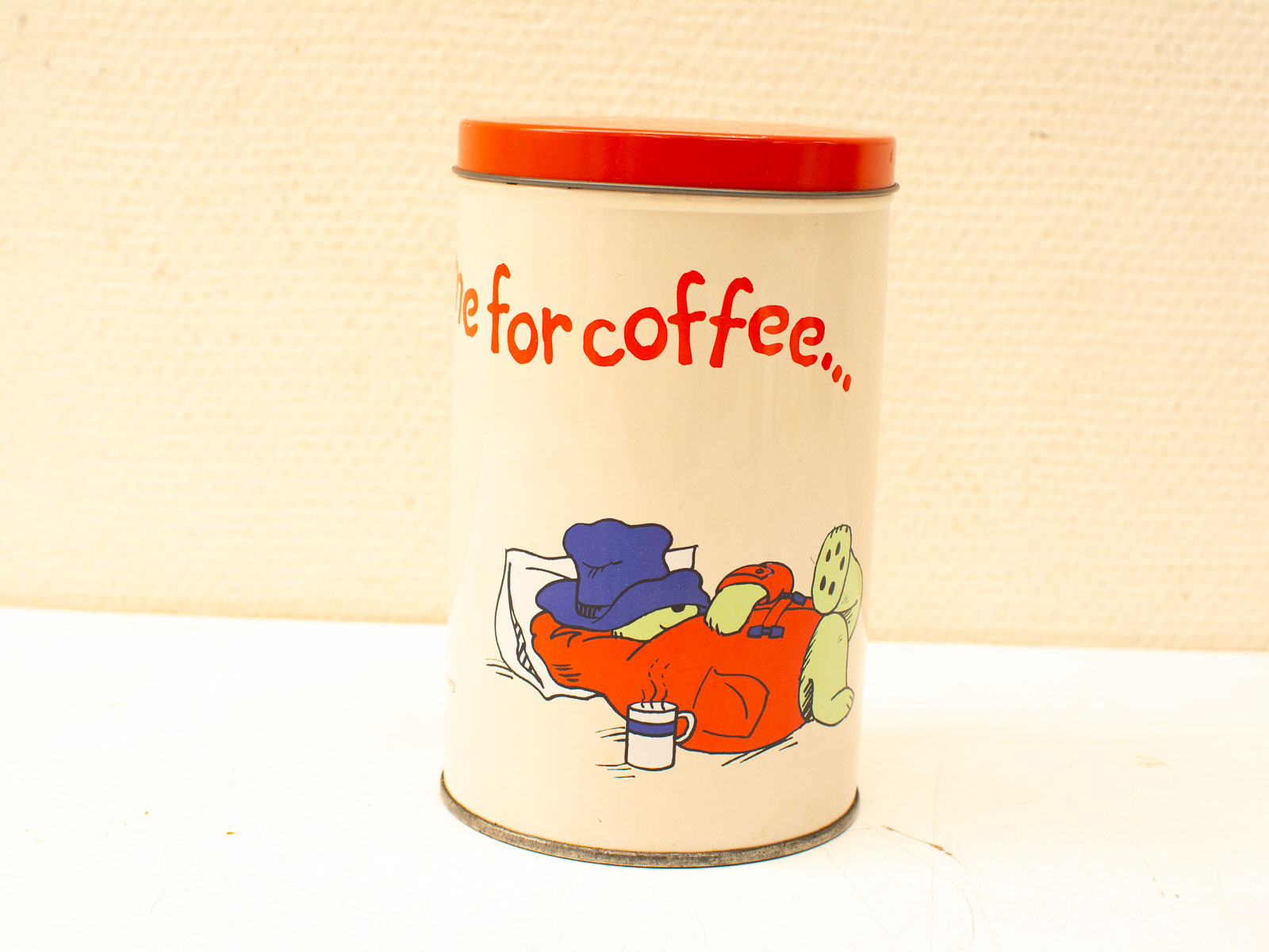 Charming vintage coffee canister with whimsical design and cozy character illustration for kitchen decor.