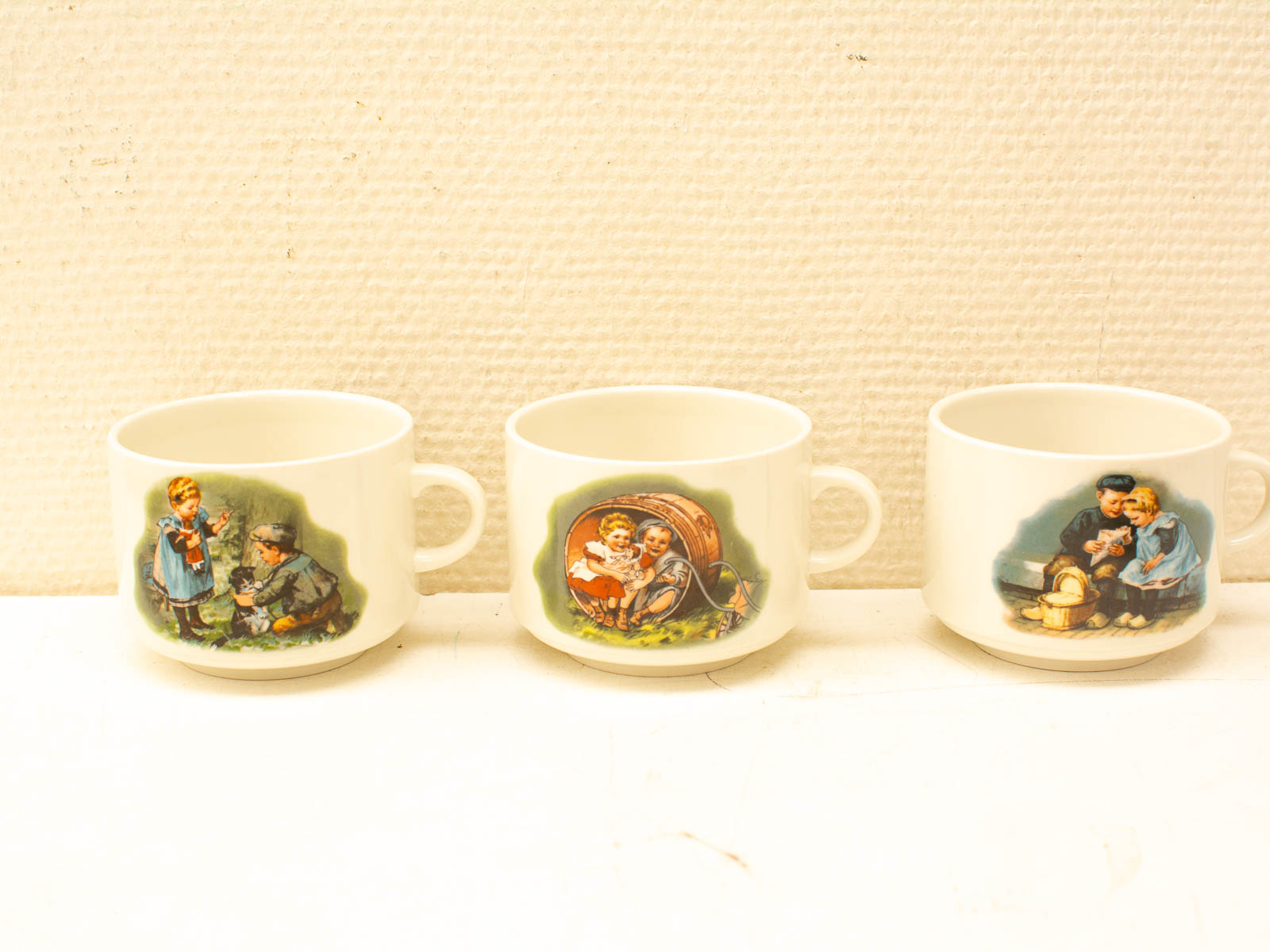 Charming vintage cups with playful childrens illustrations, perfect for collectors and nostalgia lovers.