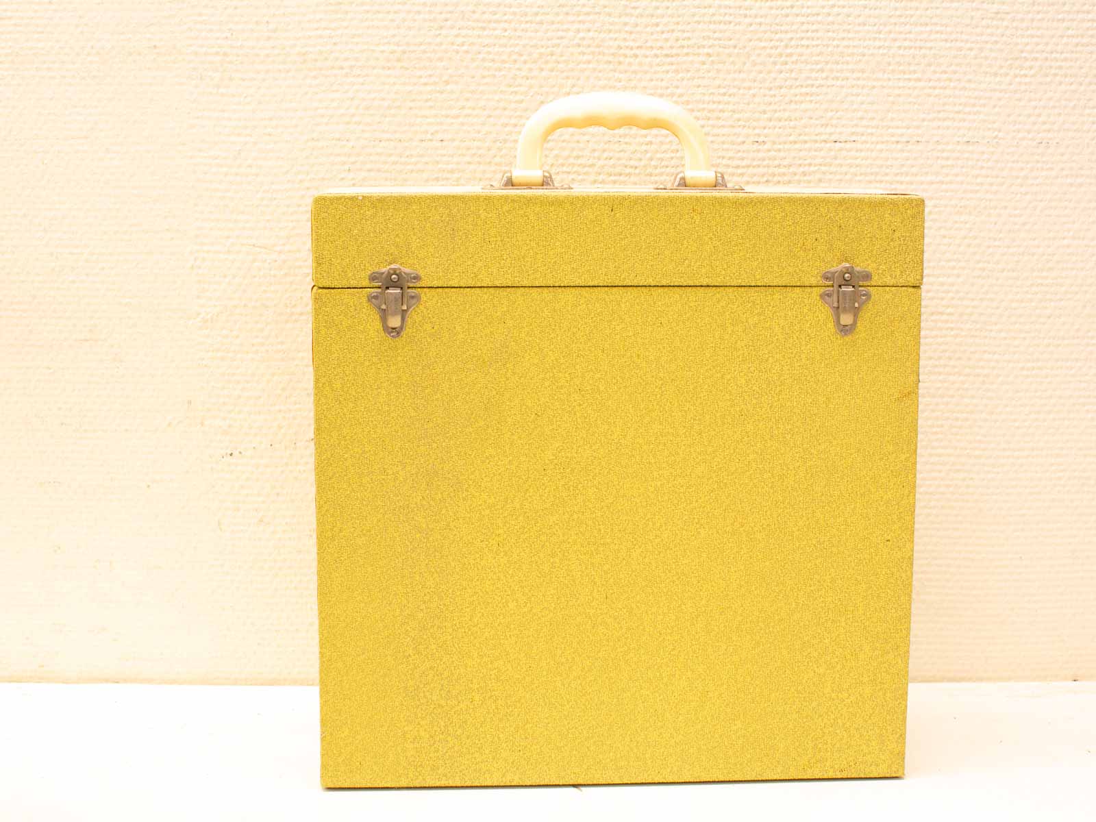 Cheerful vintage yellow glitter case with cream handle, perfect for travel or storage.