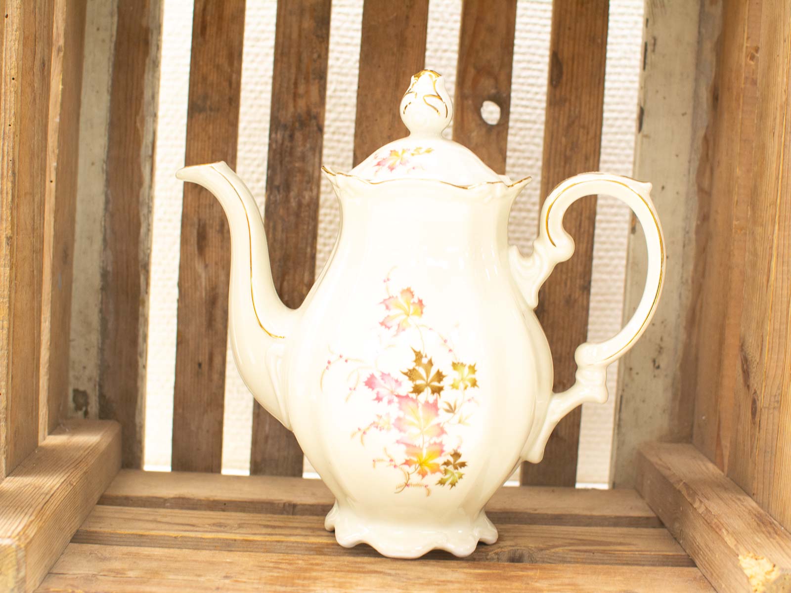 Elegant vintage porcelain teapot with floral design, perfect for nostalgic tea moments.