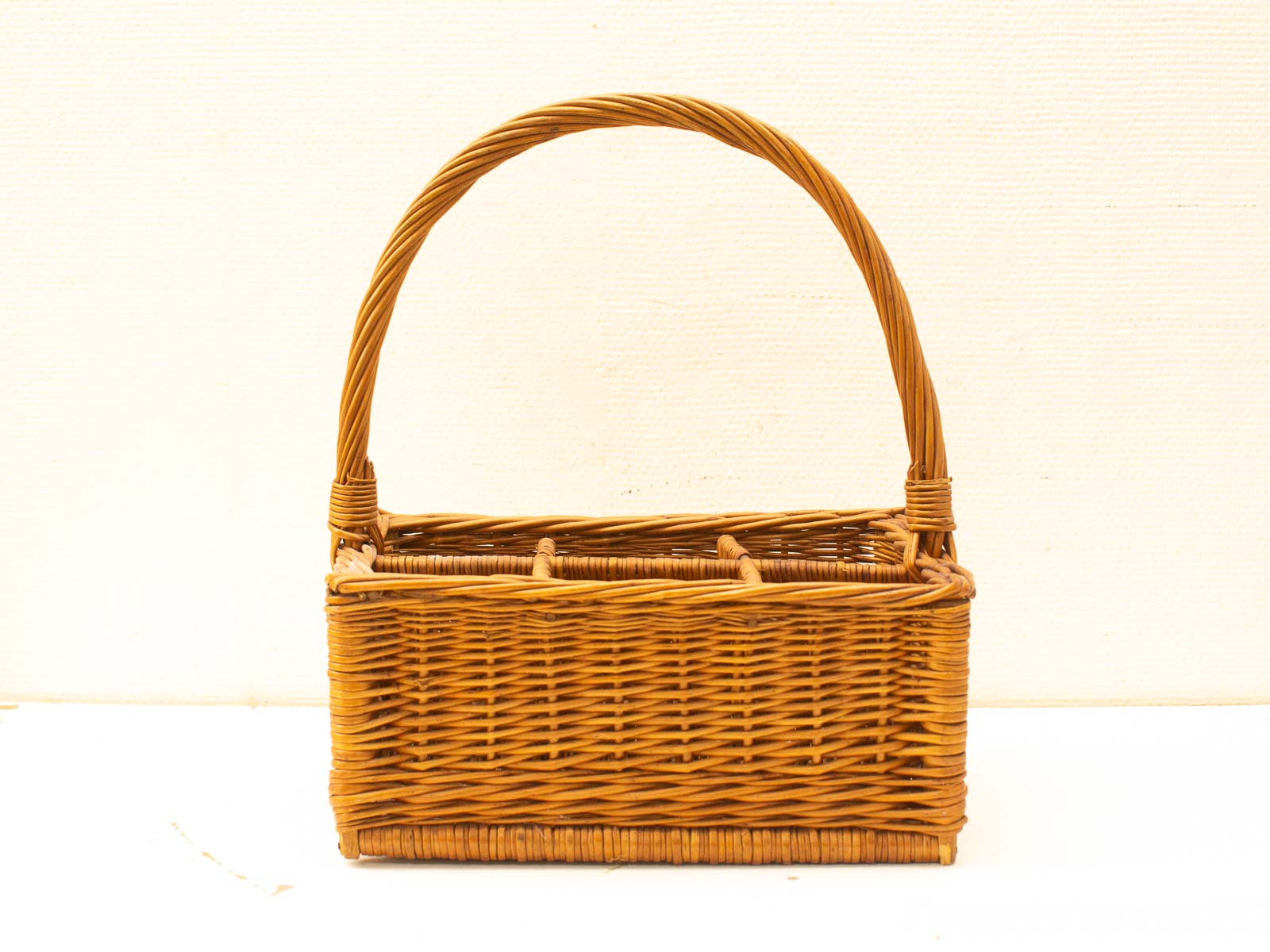 Handcrafted wicker basket: functional organizer with rustic charm and segmented interior.