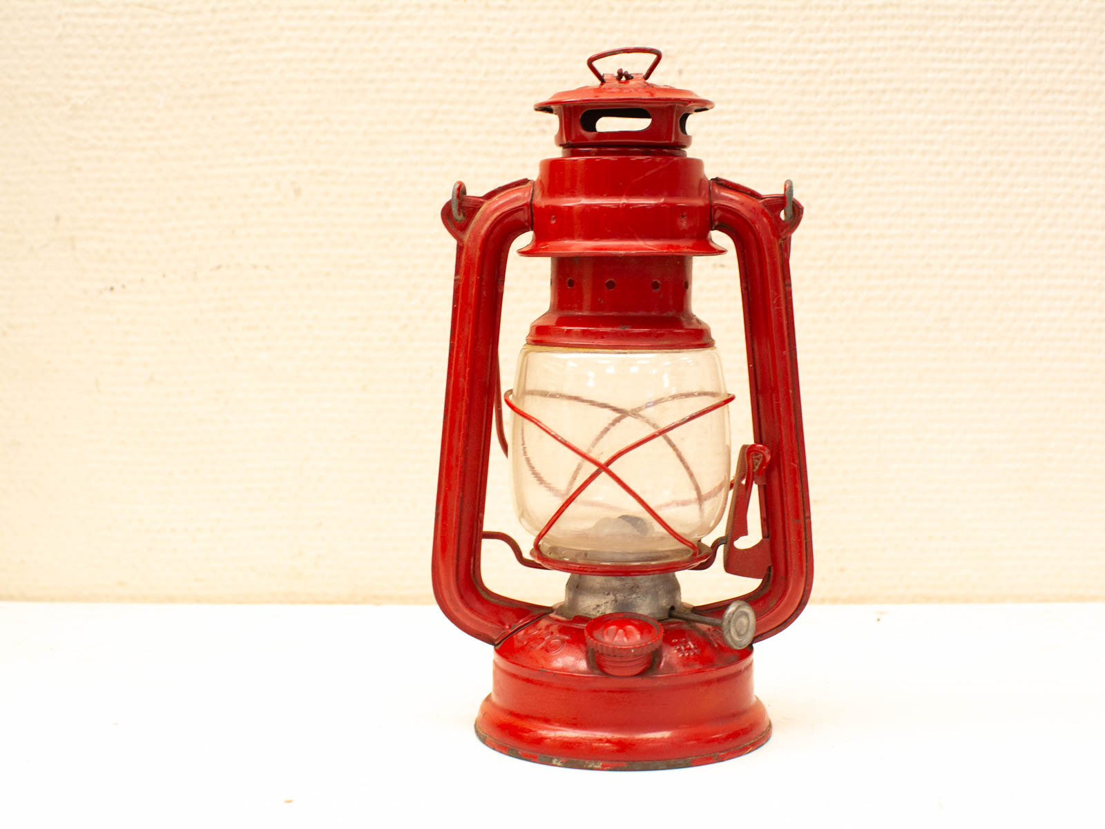 Charming vintage red glass and metal lantern, perfect for nostalgic home decor.