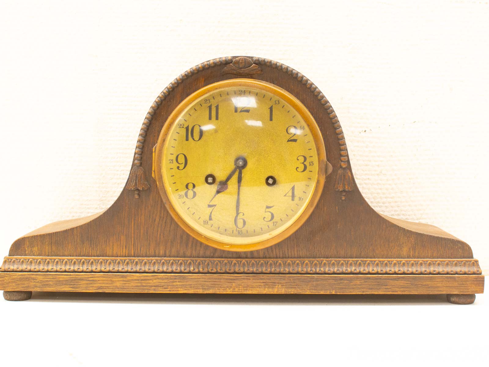 Elegant vintage tabletop clock with rich wood finish and intricate details, perfect for timeless decor.