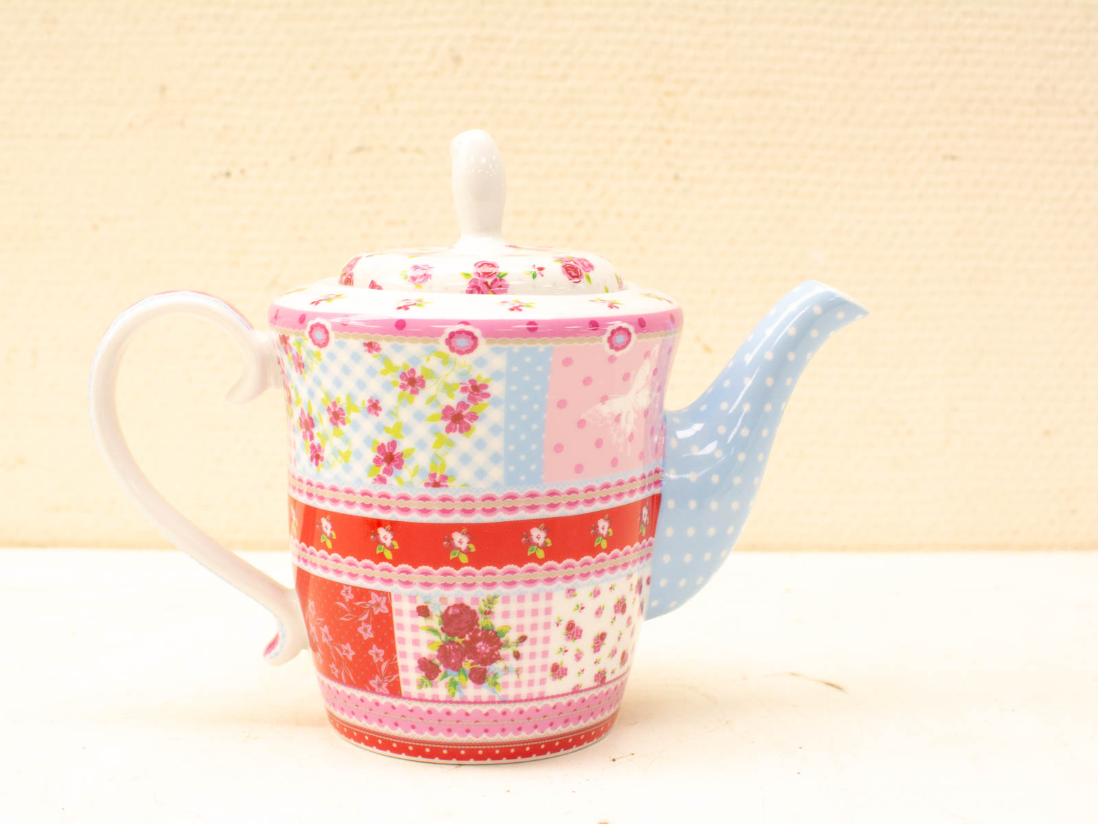 Whimsical vintage floral teapot with vibrant patterns, perfect for cozy tea parties and collectors.