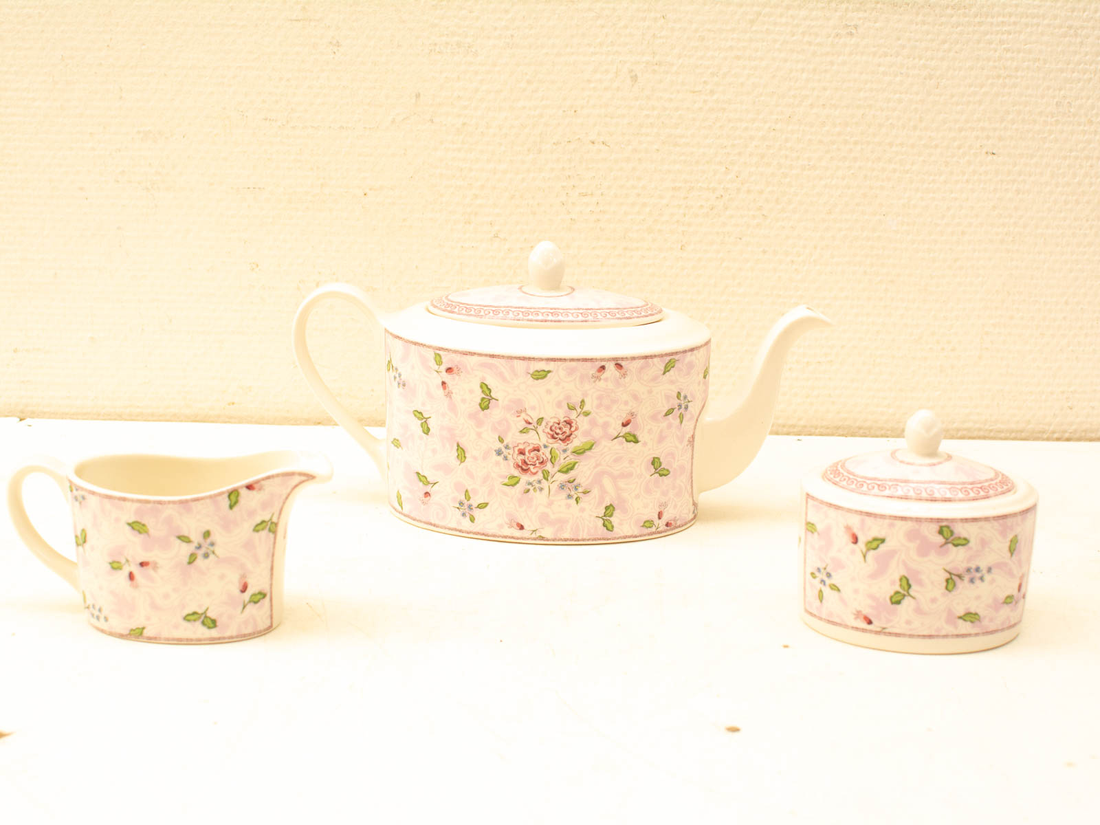 Elegant vintage porcelain tea set with floral design, perfect for afternoon tea gatherings.