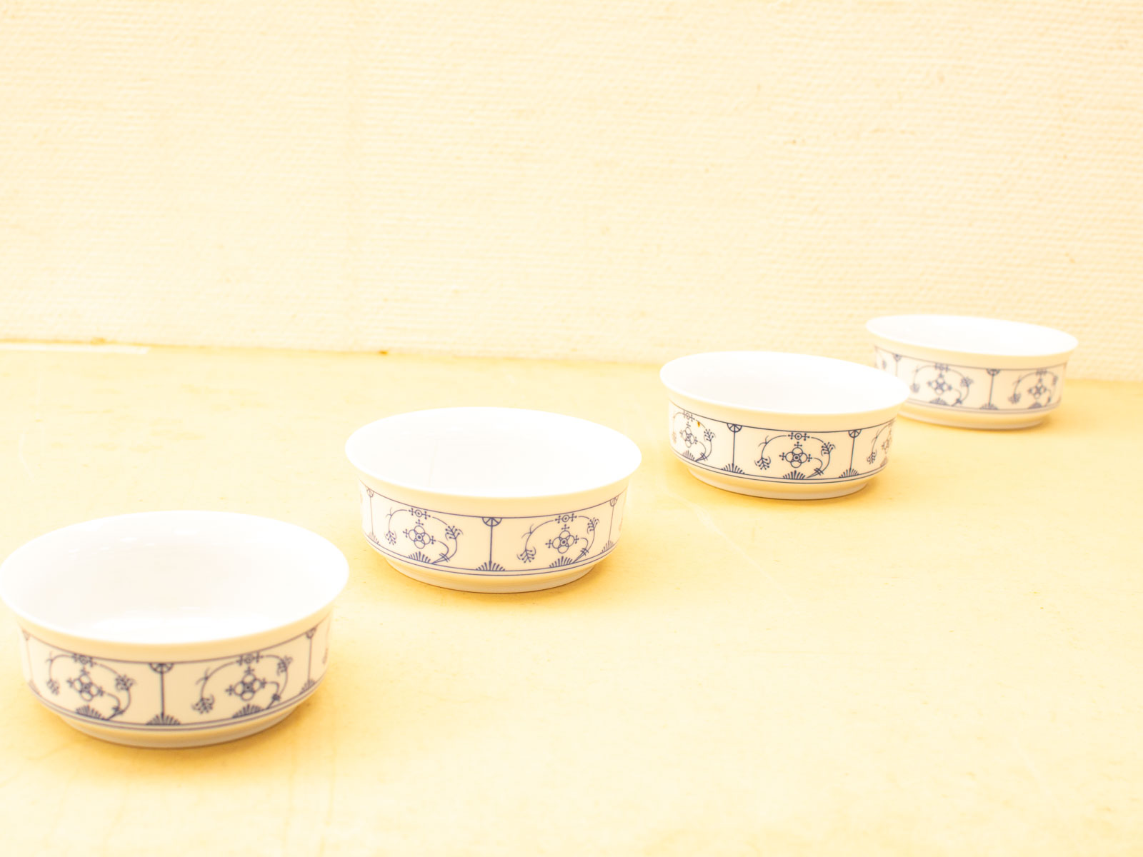 Elegant white ceramic bowls with blue patterns, perfect for timeless table settings and gifts.