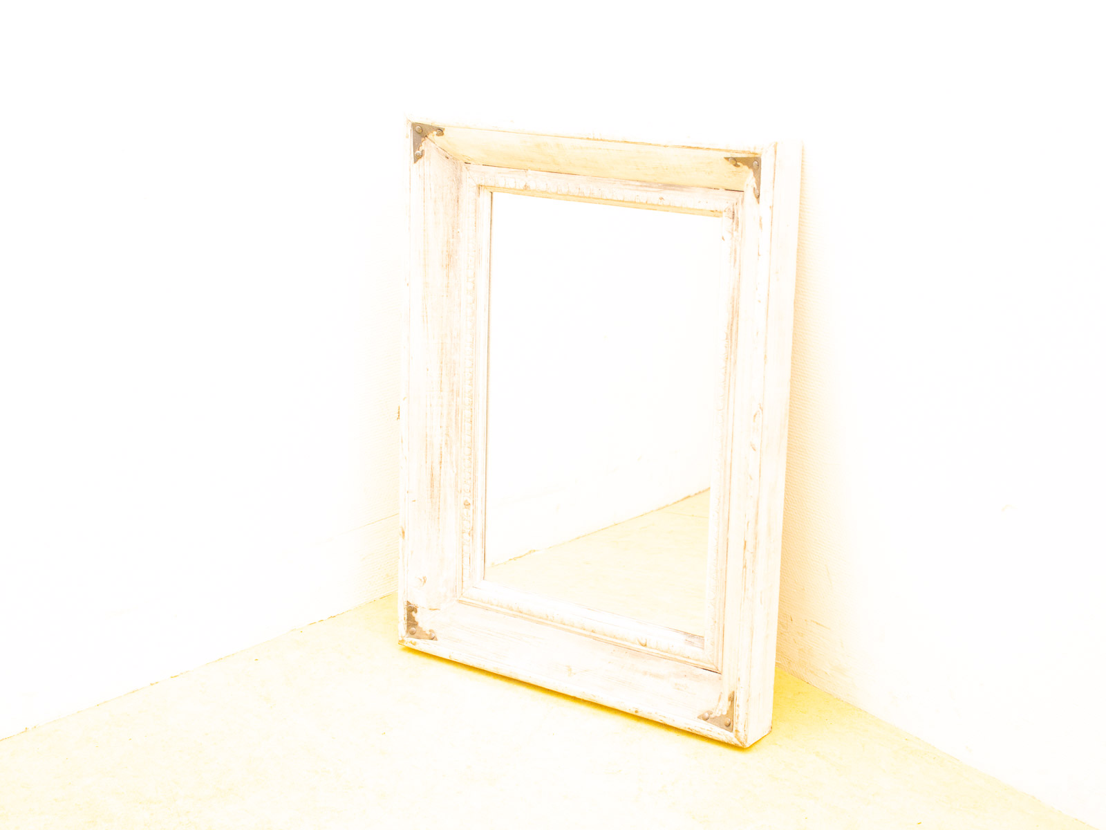 Charming vintage white mirror with rustic frame, perfect for adding character to any room.