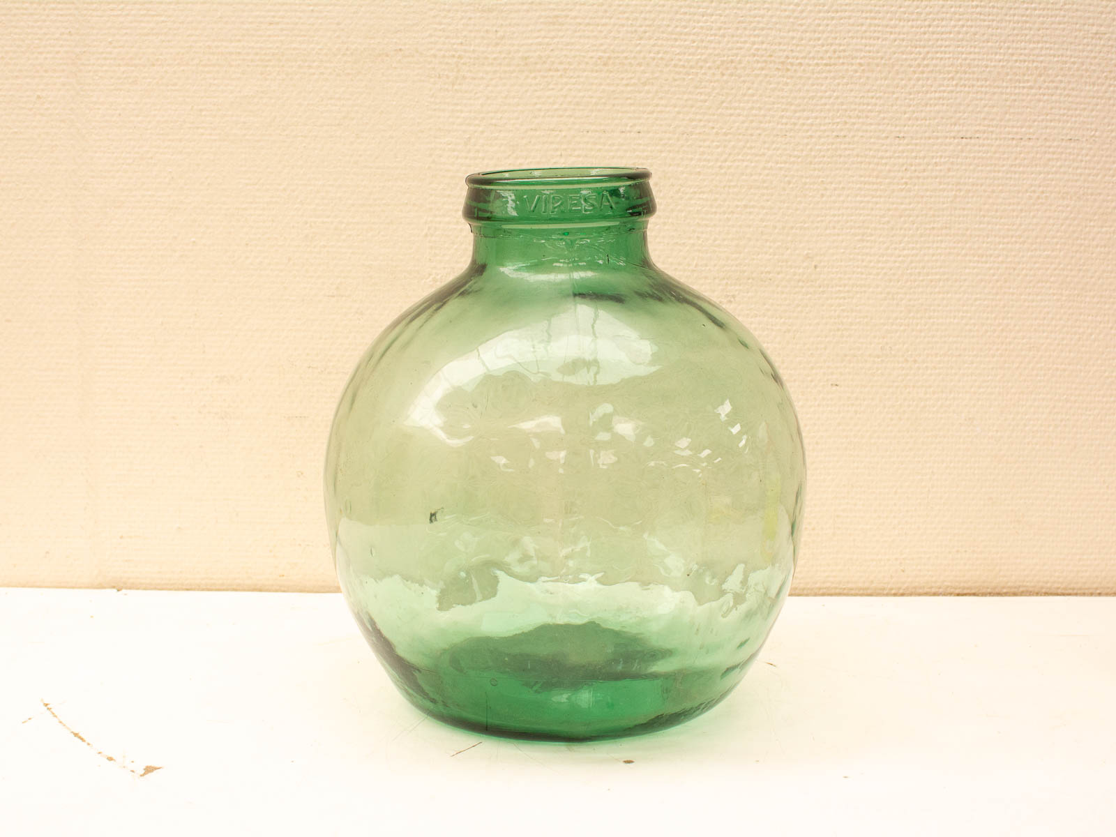 Vibrant green glass jar, perfect for storage or decor in any style.