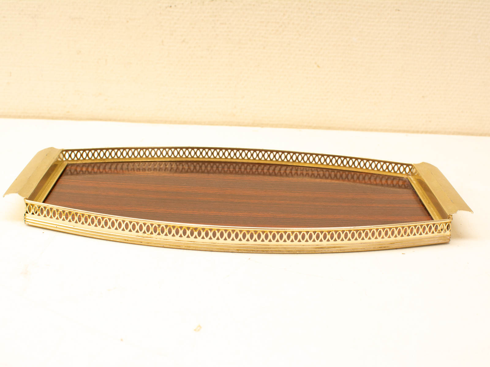 Elegant vintage serving tray in dark wood with gold-tone metal lattice for stylish entertaining.