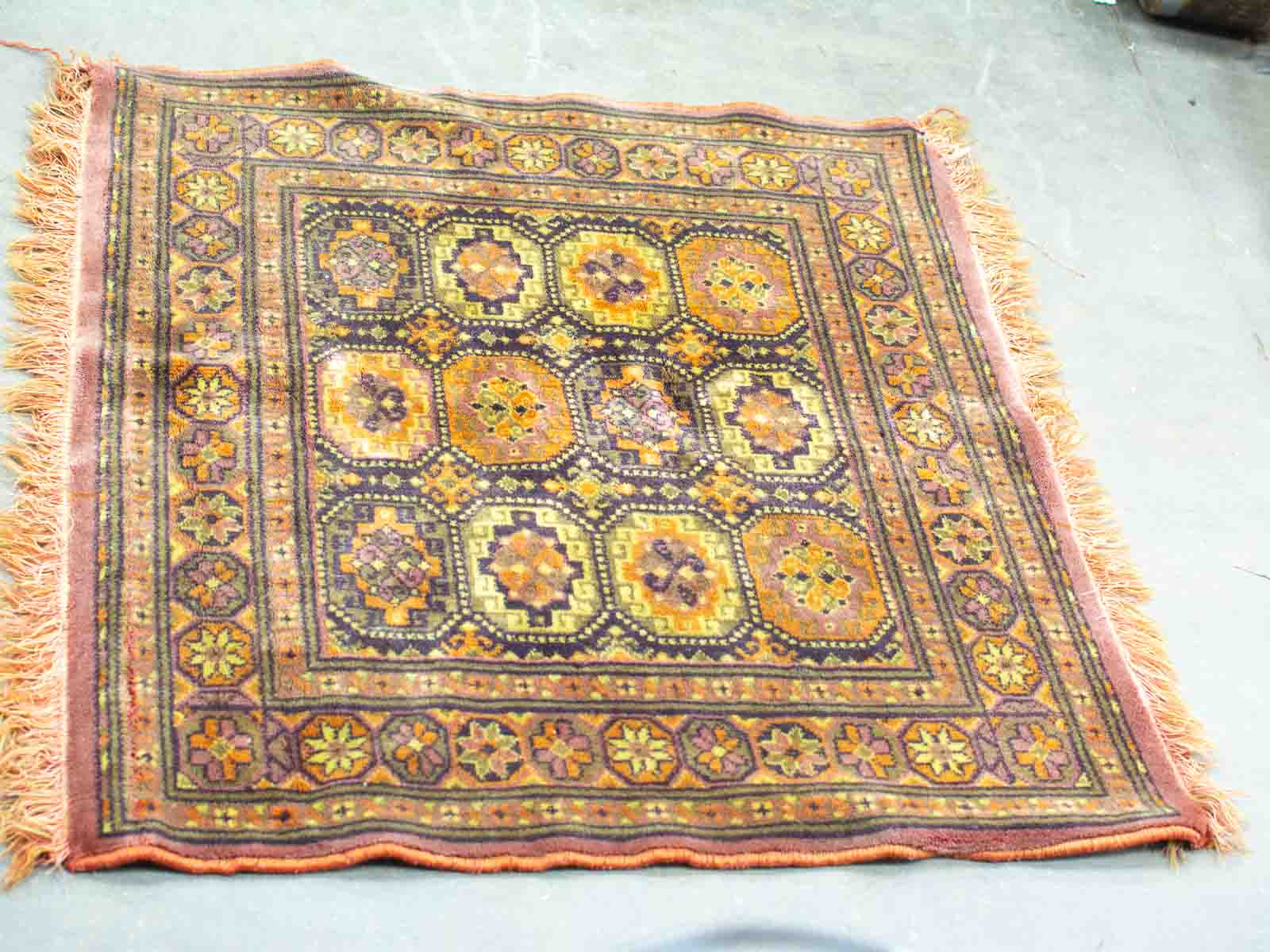 Vibrant vintage woven rug with geometric patterns in warm colors, perfect for enhancing any space.