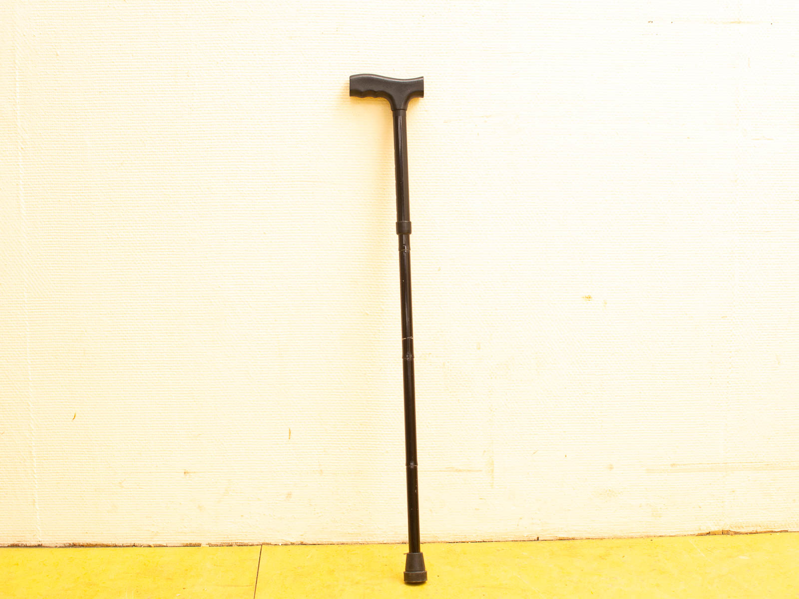 Stylish adjustable black walking cane for stability and comfort, perfect for mobility support.