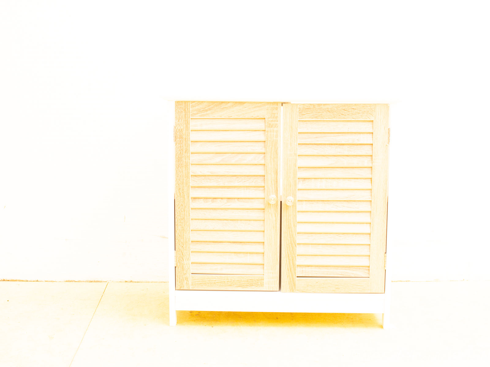 Stylish minimalist wooden cabinet with louvered doors for versatile, ventilated storage in any space.