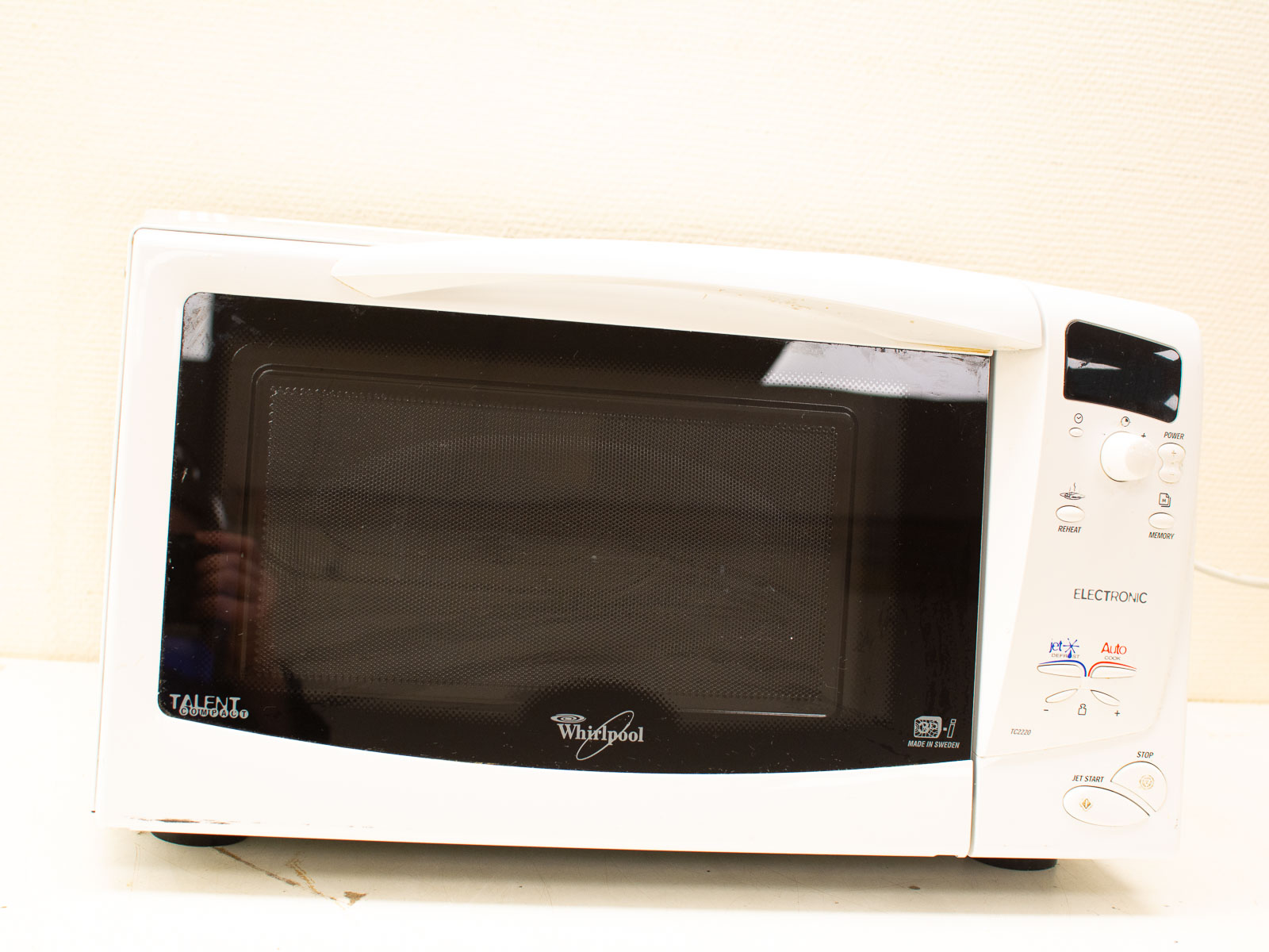 Sleek white Whirlpool microwave with glass door and intuitive controls, perfect for quick meal prep.