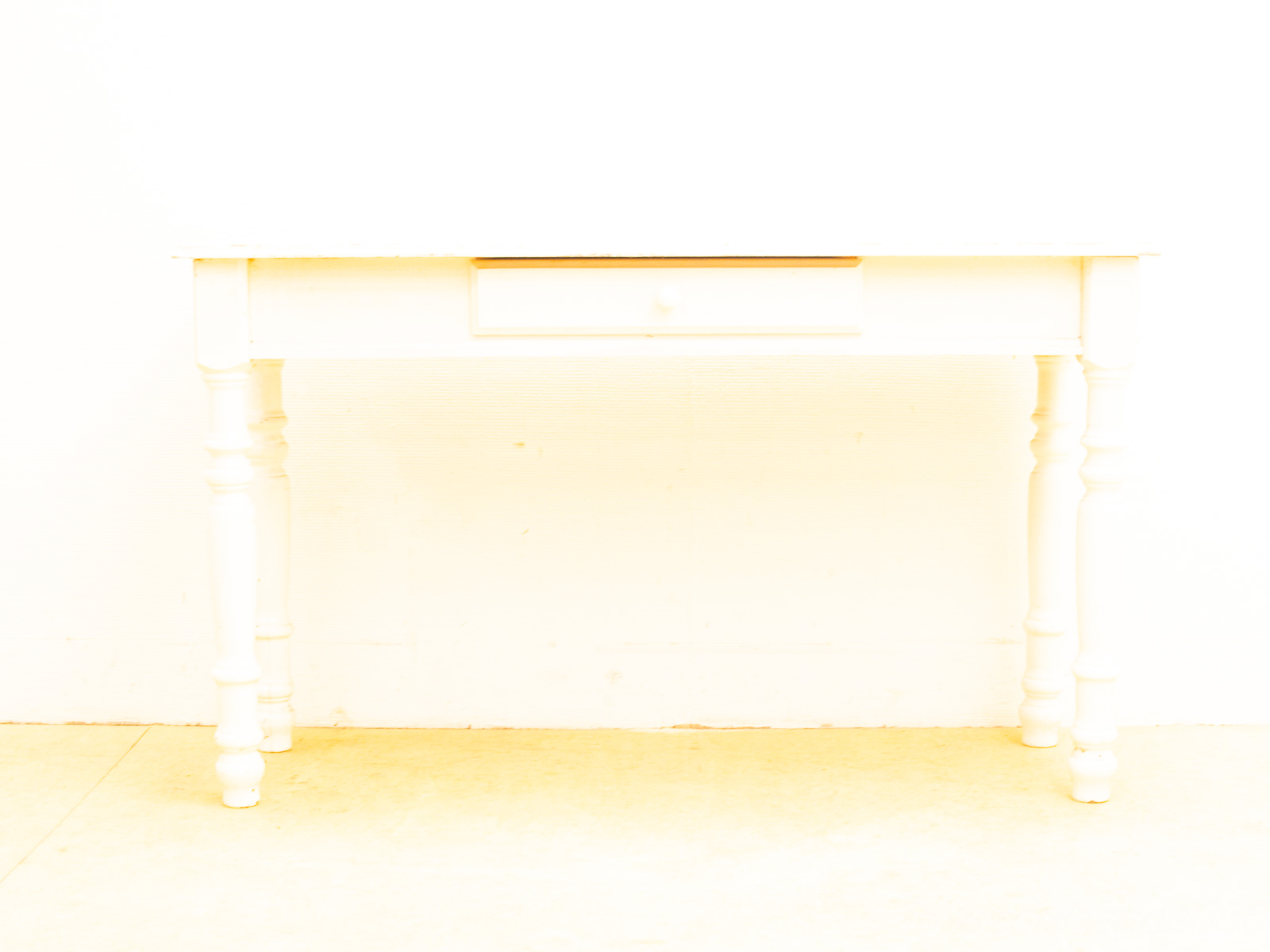 Elegant white wooden table with drawer, perfect for vintage and minimalist interiors.