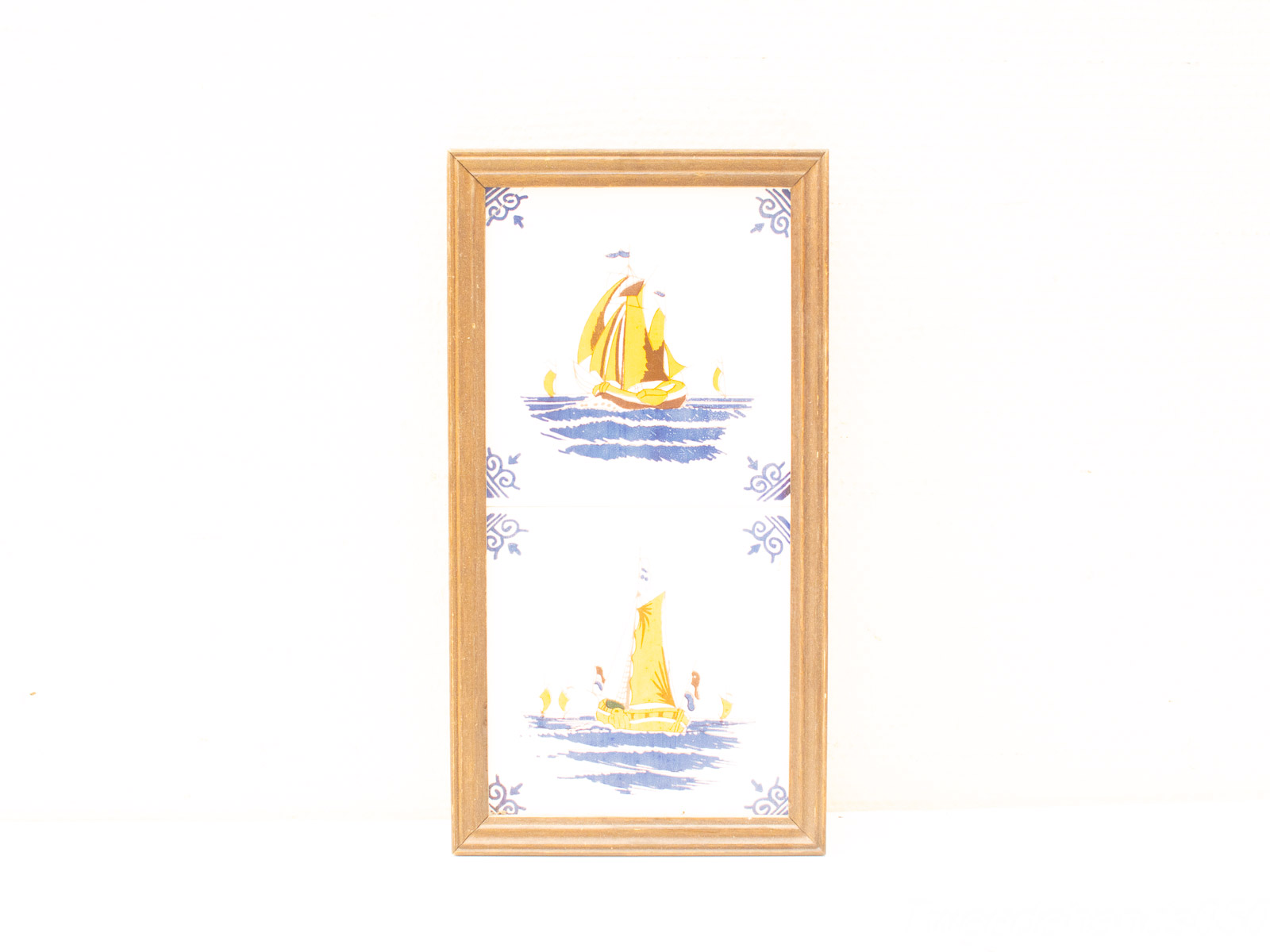 Charming nautical artwork of vintage sailboats in light wood frame, perfect for maritime decor.