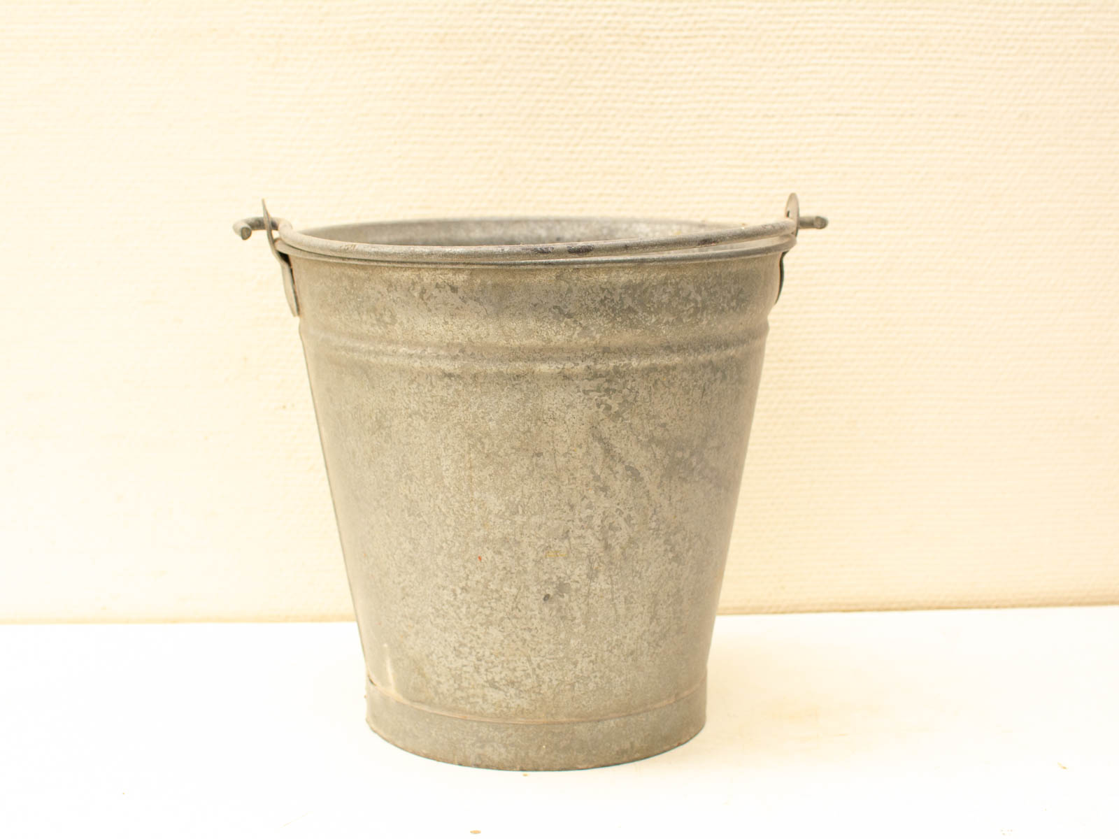 Vintage galvanized metal bucket, perfect for rustic home decor and practical uses.