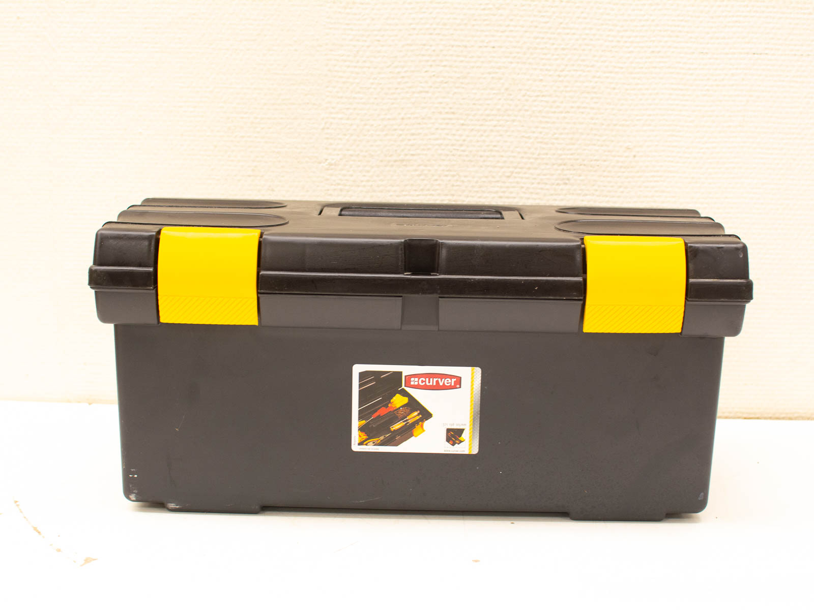 Durable black toolbox with yellow accents, ideal for organizing tools and DIY projects.