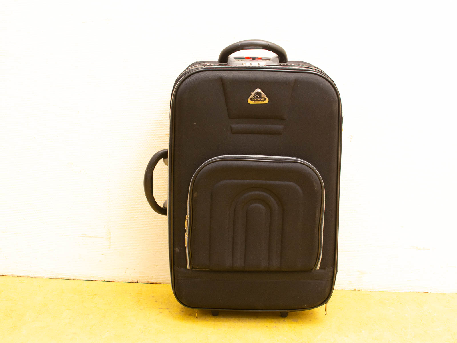 Sleek black suitcase with wheels and handle, perfect for modern travel needs.