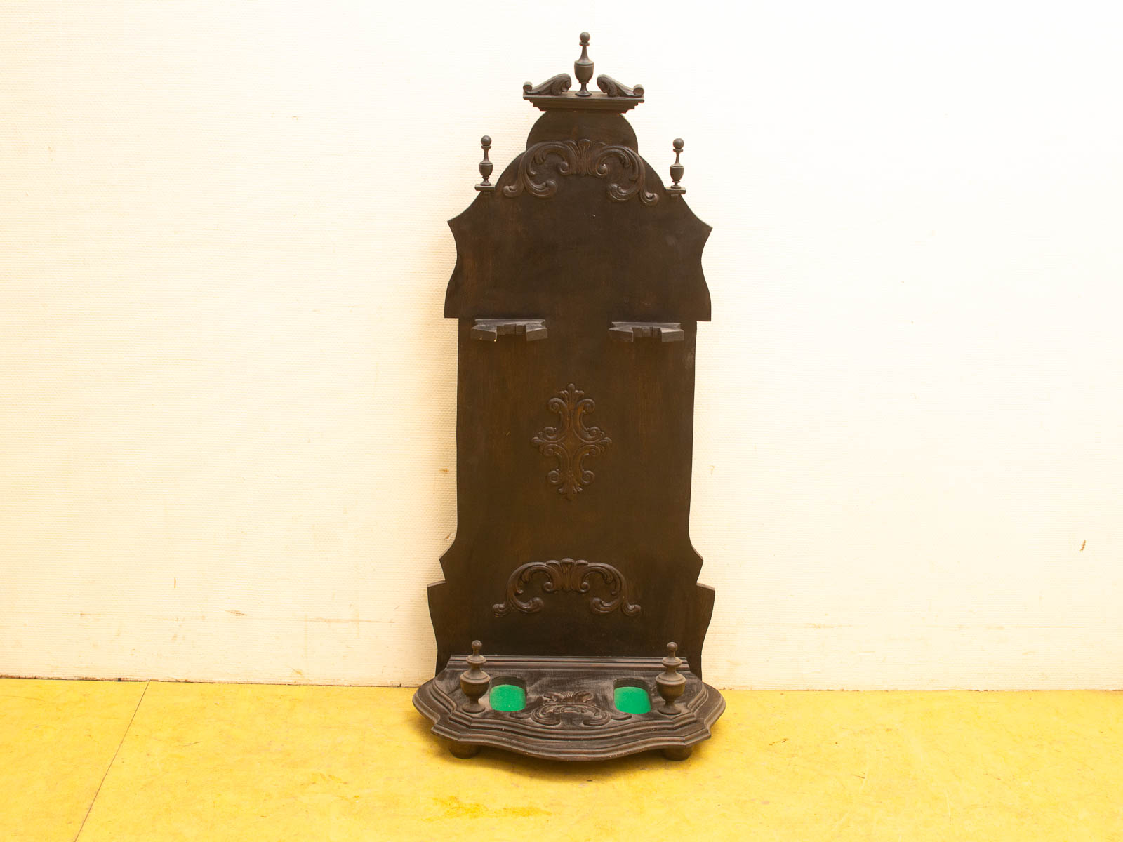 Antique wooden hall tree with detailed carvings and elegant hooks, perfect for vintage decor.