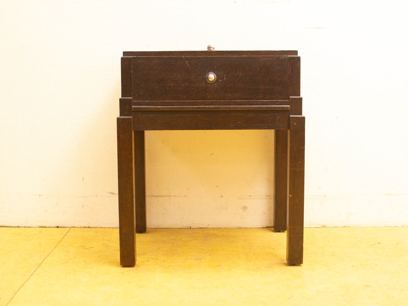 Stylish dark wooden nightstand with minimalist design, perfect for any interior decor style.