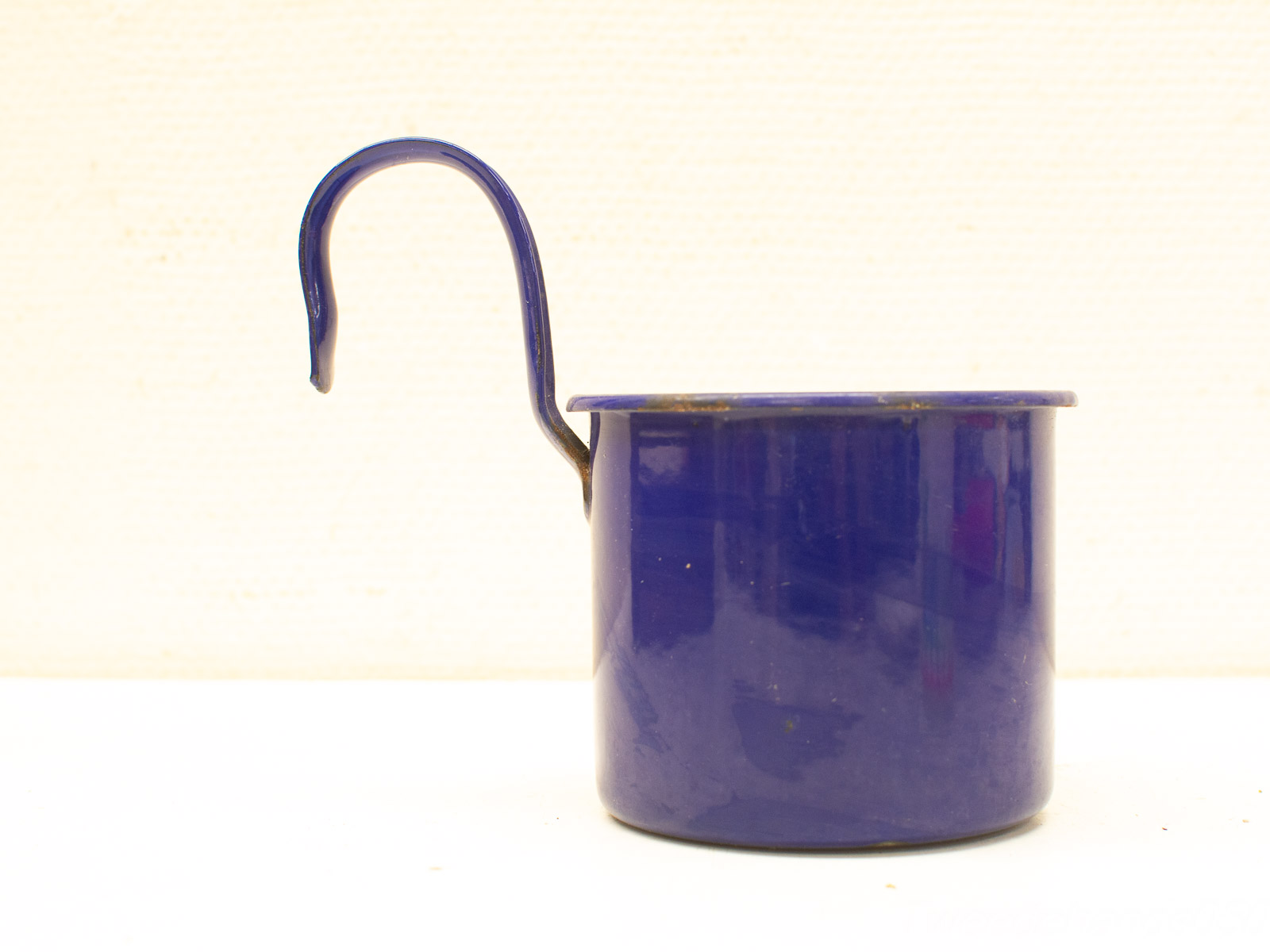 Vintage blue ceramic pot with elegant handle, showcasing signs of past use and nostalgic charm.