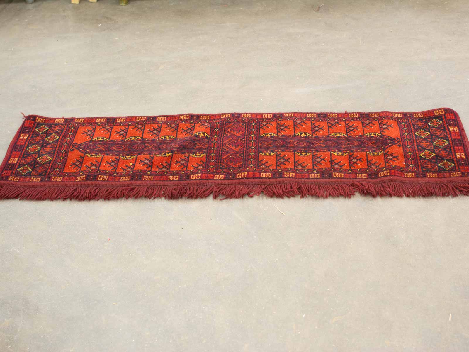 Vibrant handwoven red vintage rug showcasing intricate geometric patterns and traditional craftsmanship.