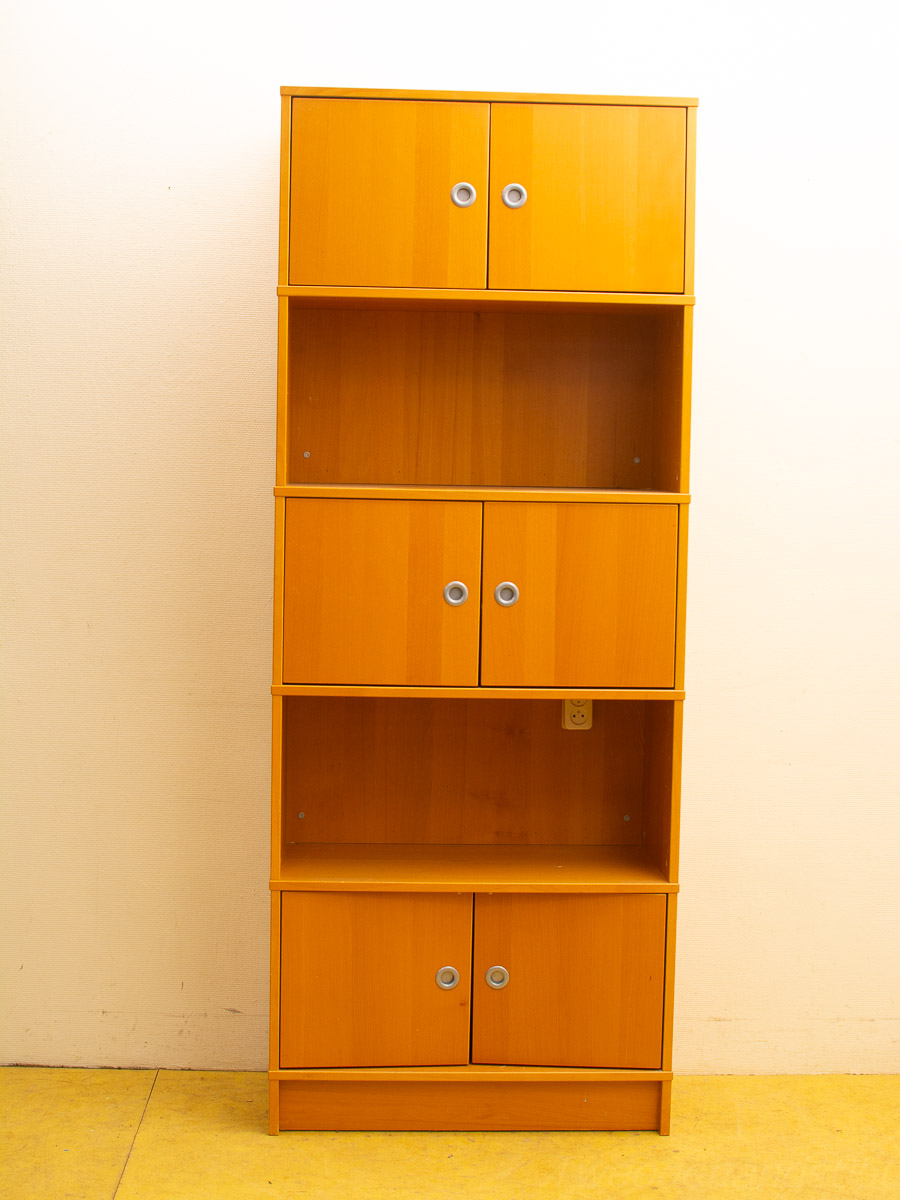 Vintage wooden bookcase with silver handles, featuring spacious storage and display sections on a yellow floor.